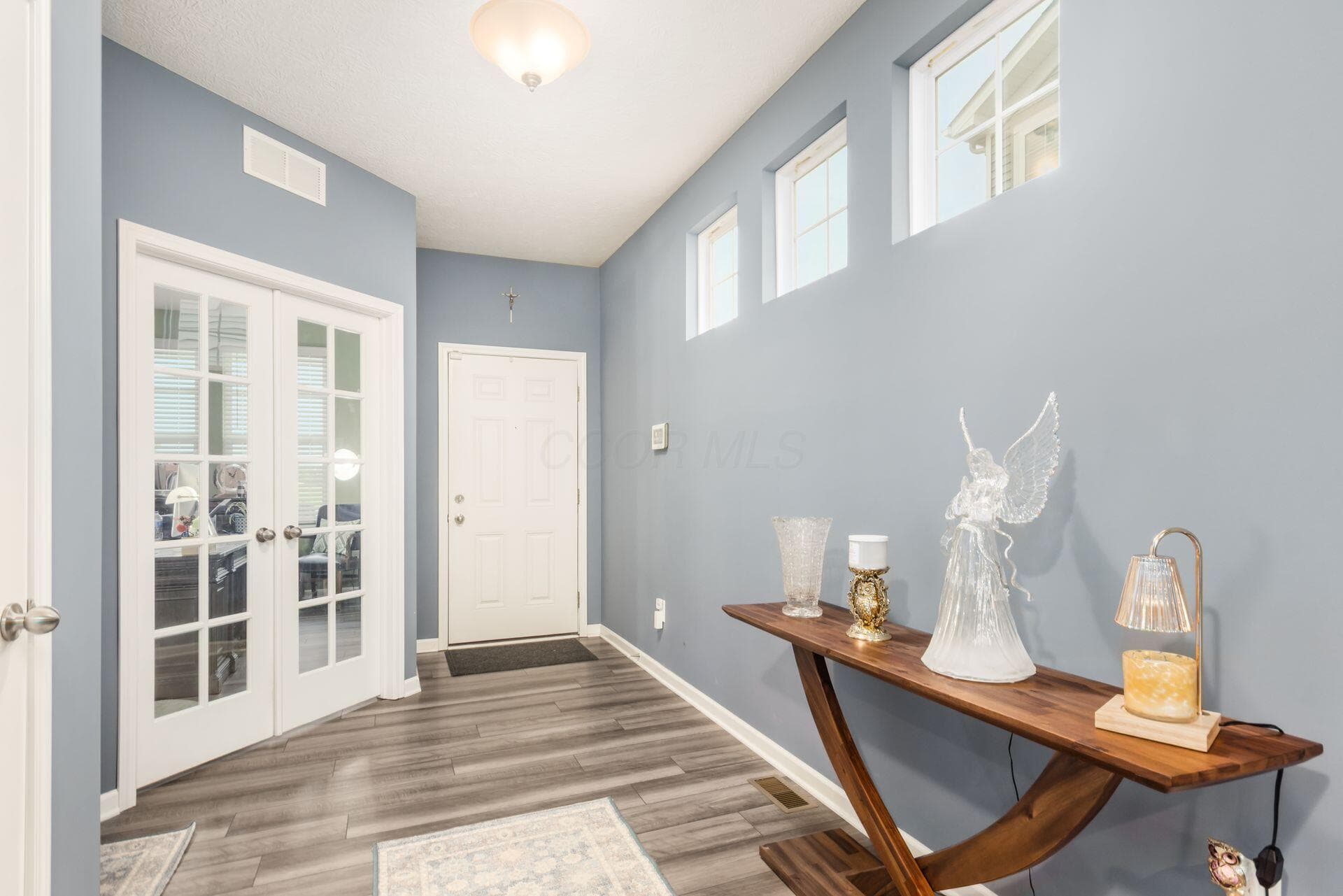 Glass doors lead to a private study off the foyer