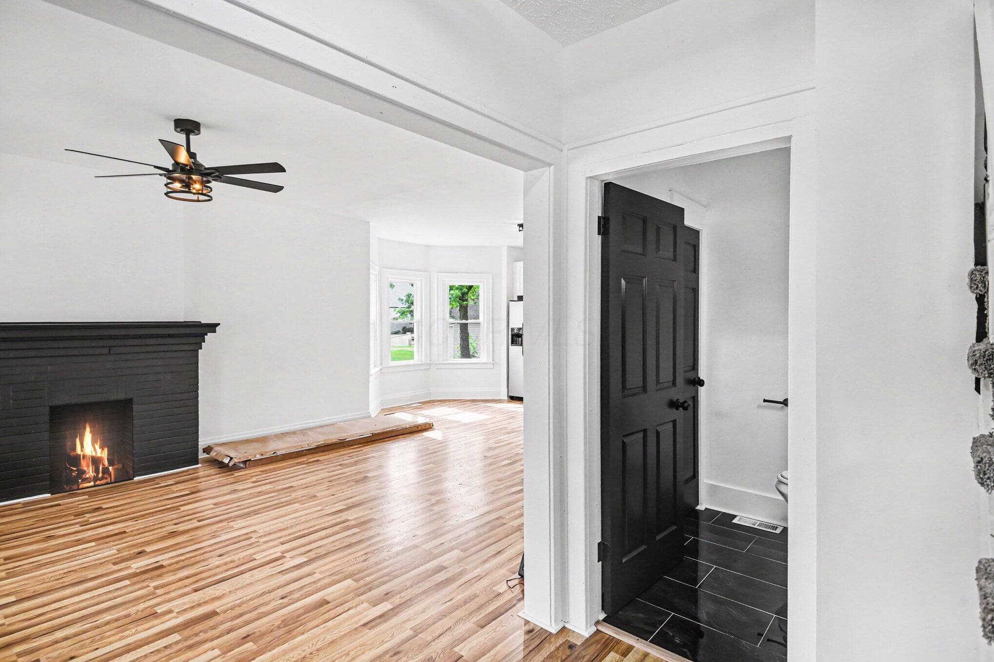 Large living room with stunning new waterproof Pergo flooring, wood burning fireplace and fully renovated half bath.