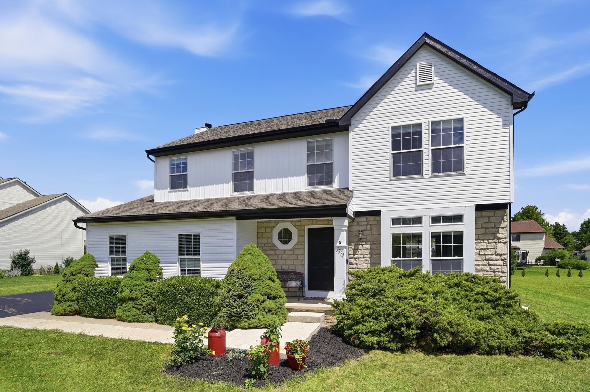 New siding, gutters, downspouts, fresh trim paint.