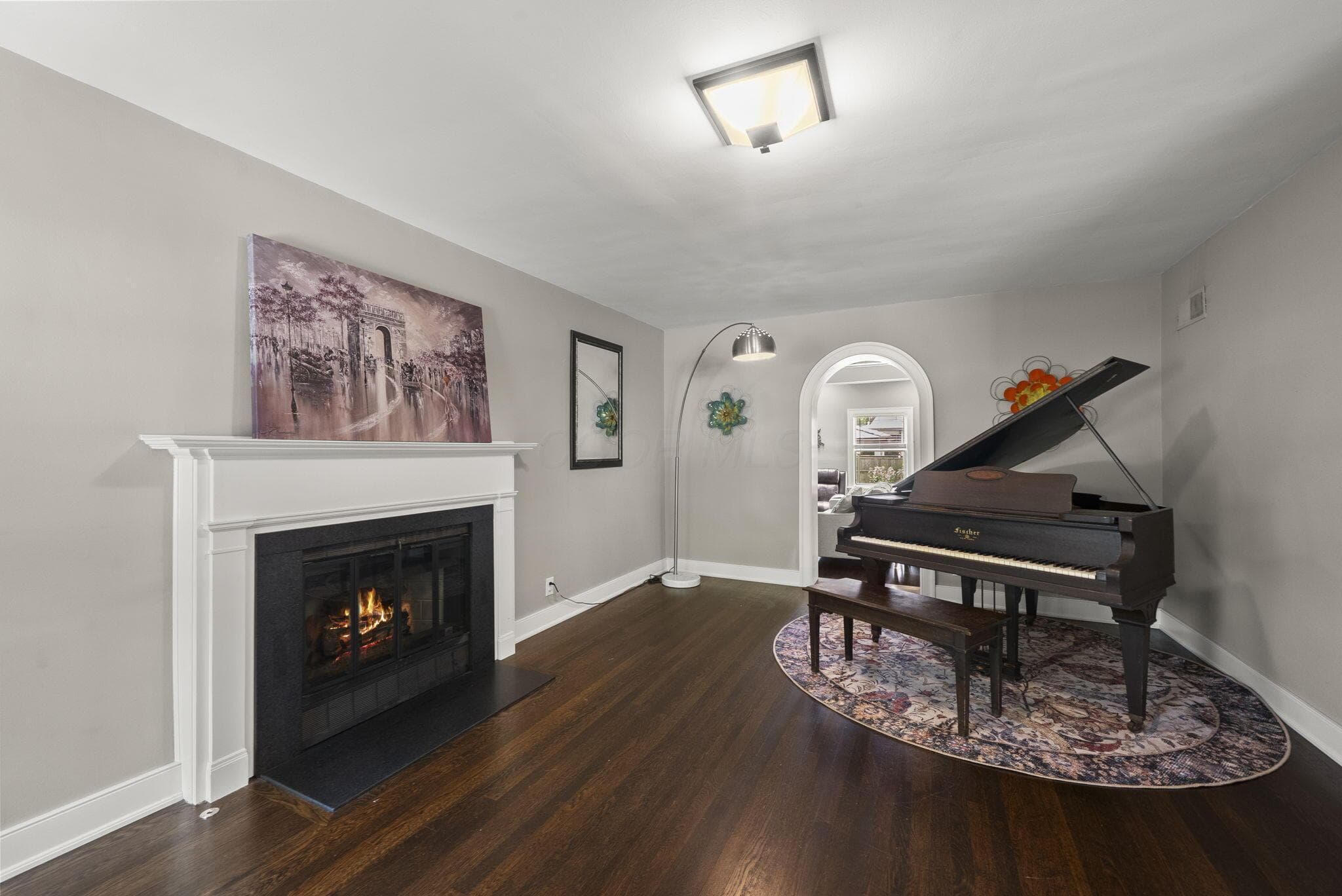 Beautiful piano room and formal sitting room with wonderful gas fireplace, beautiful hardwood floors throughout