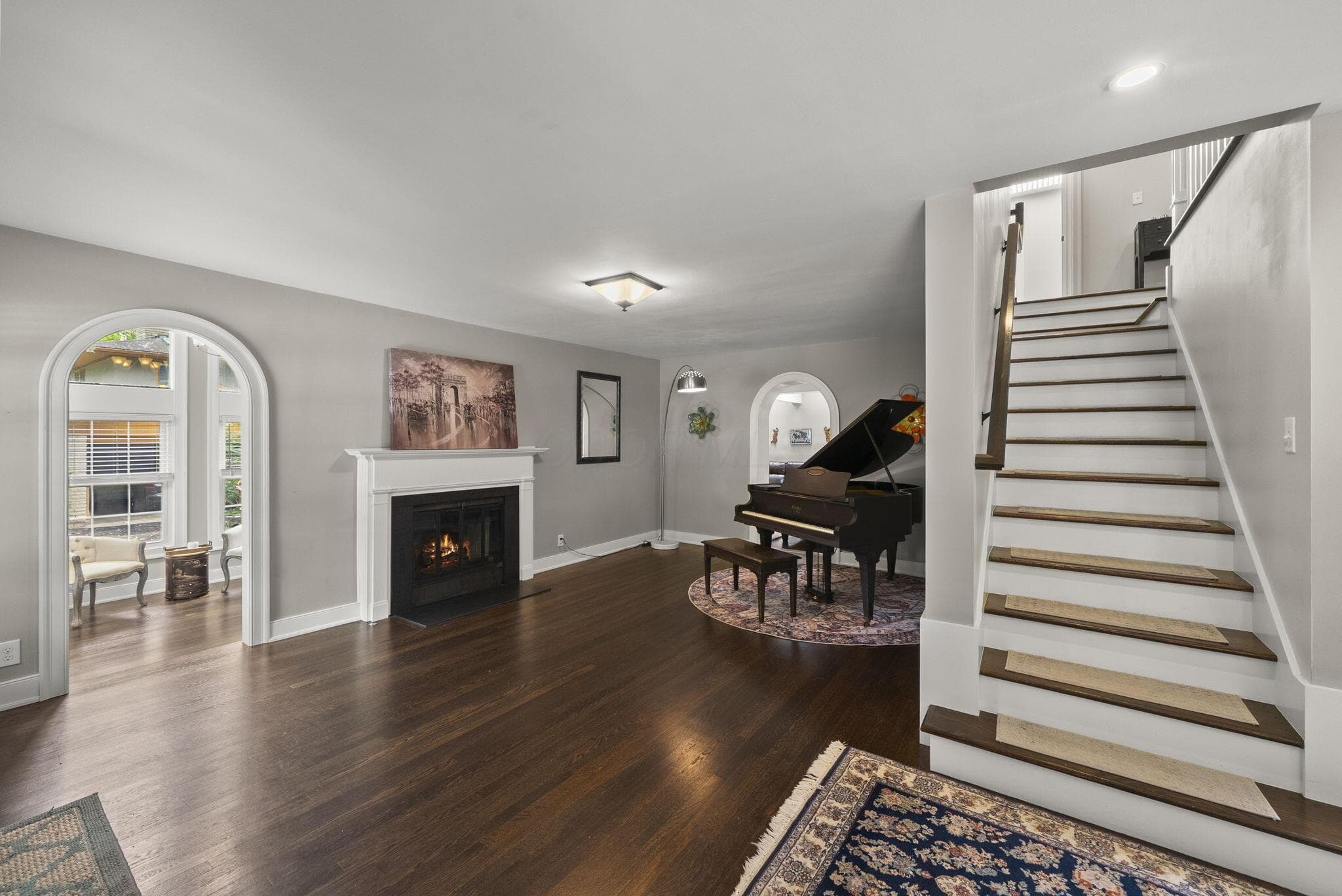 Home opens up to a beautiful fireplace and formal sitting room and current piano room.
