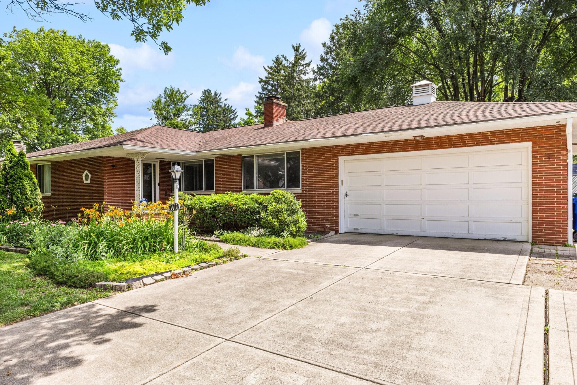 Ranch style home, w/brick exterior, large driveway, with an extra parking pad