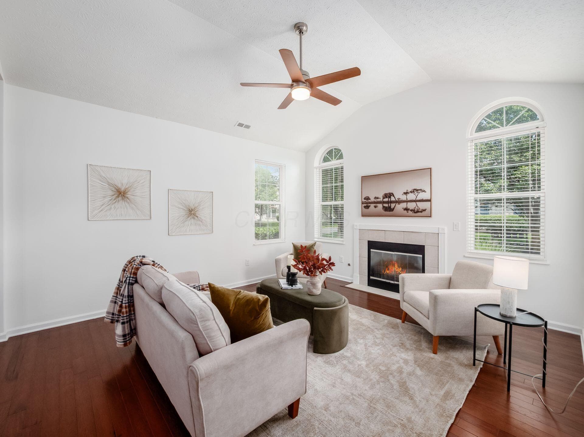 Great room features a cathedral ceiling and gas log fireplace.