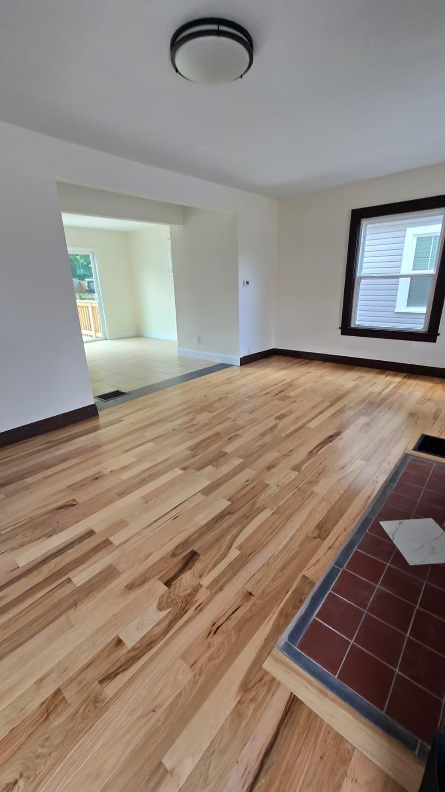 Refinished wood-finish flooring extends throughout this bright living space