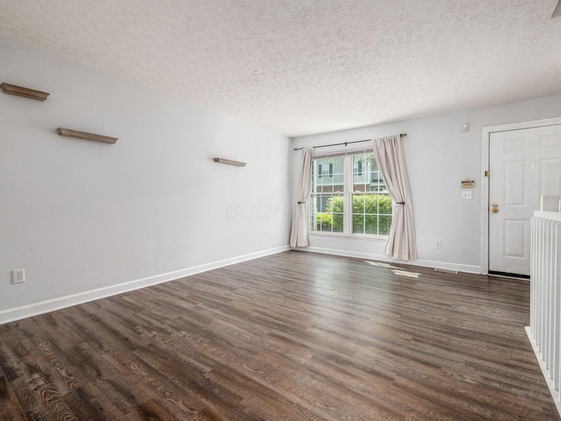 View to front window from near stairs to lower level.