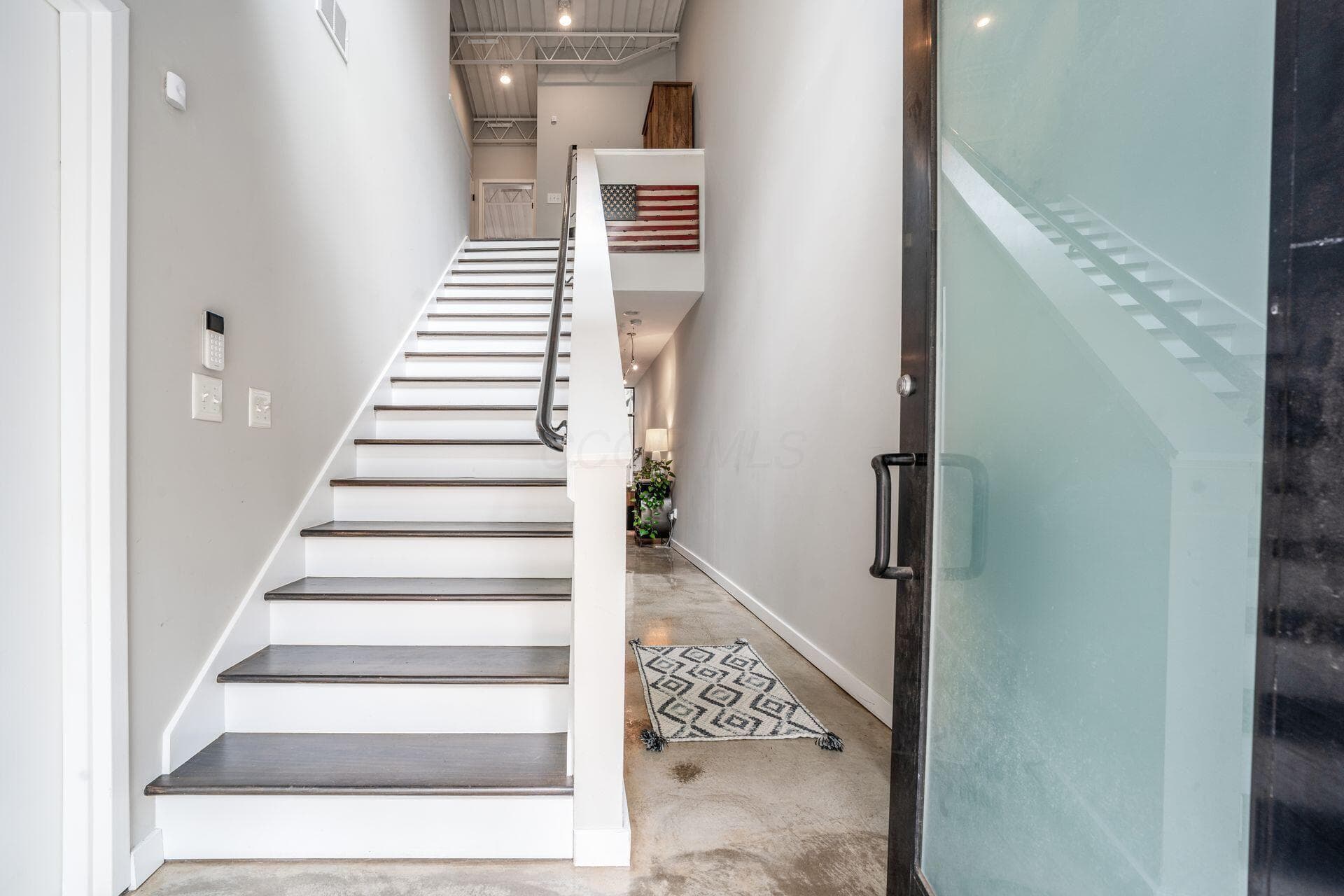 Front entrance view. Hall to right leads to the main living space. Stairs up to beds baths & laundry!