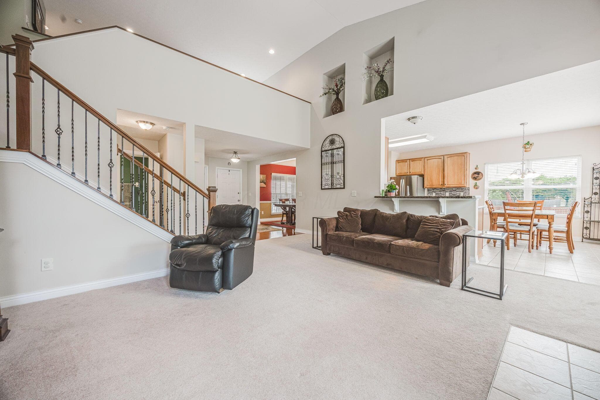 Spacious great room with vaulted ceiling and stained glass windows