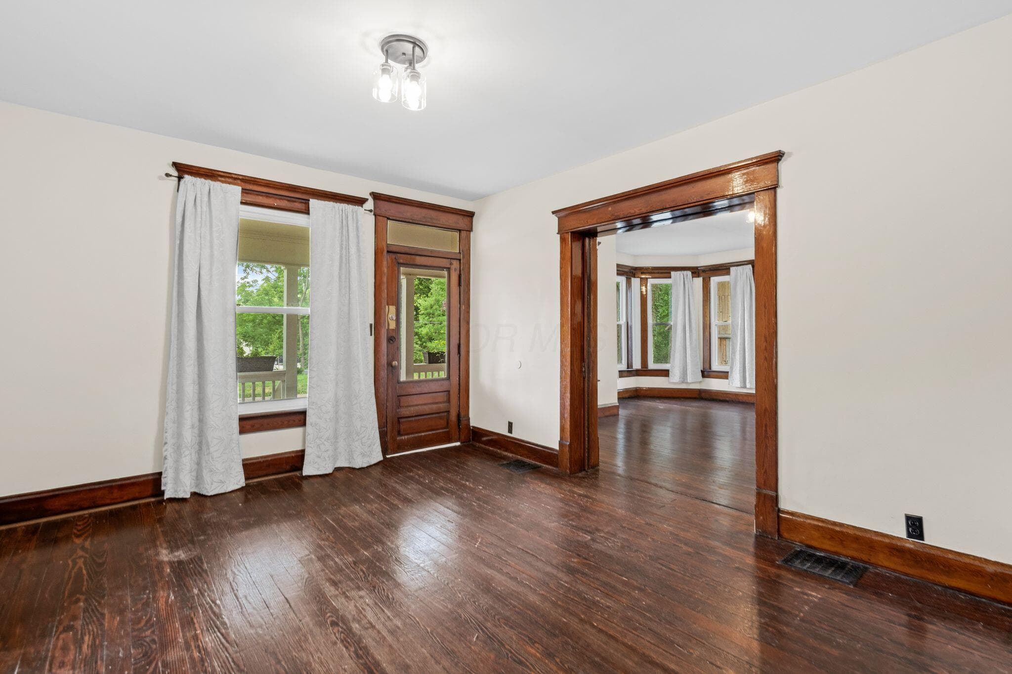 Dark wood-finish flooring with rich wood trim throughout