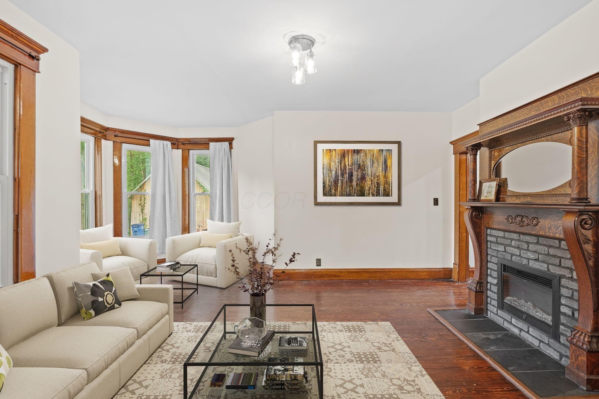 Virtual Staging. Ornate wood mantel fireplace with a black stone hearth and gray brick surround
