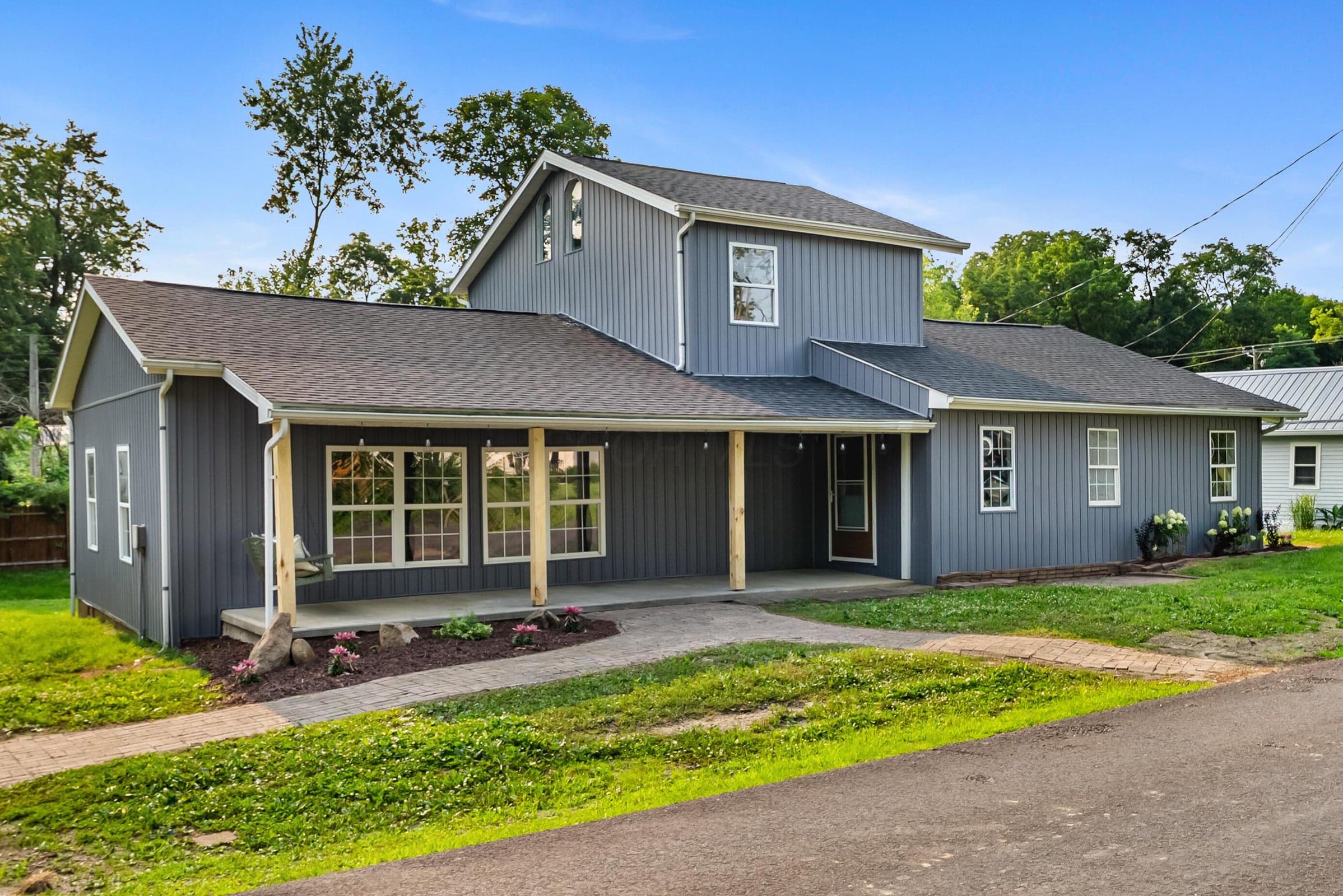 Beautiful street view with large covered porch with swing.