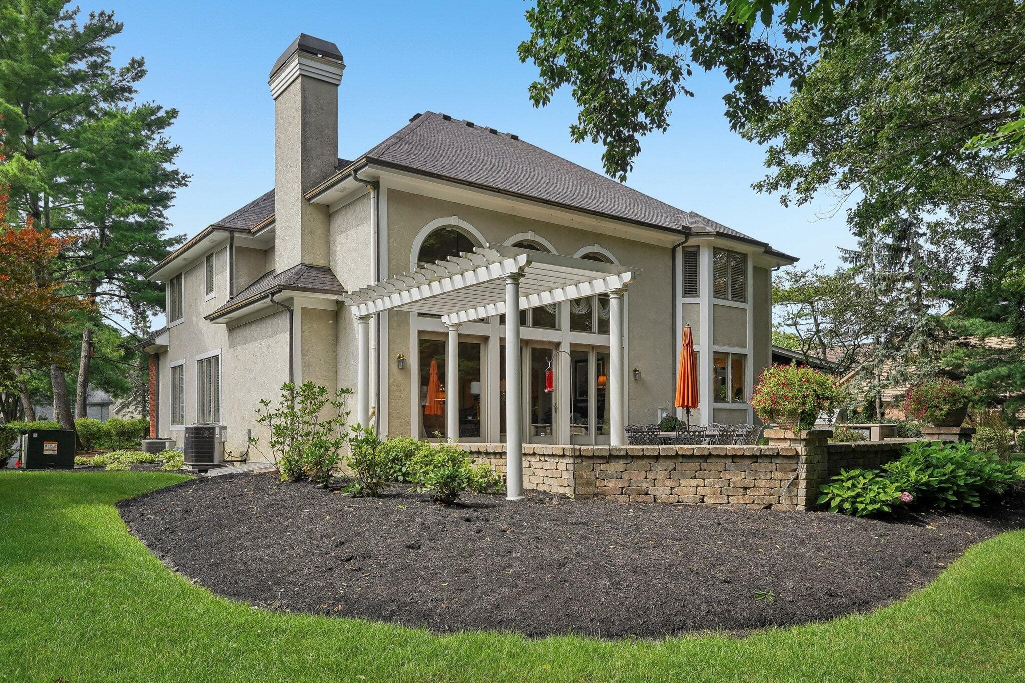 Pergola and patio overlooking the landscaped backyard.