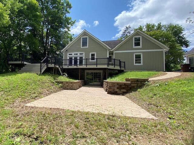 Back of house with view of lower level patio.
