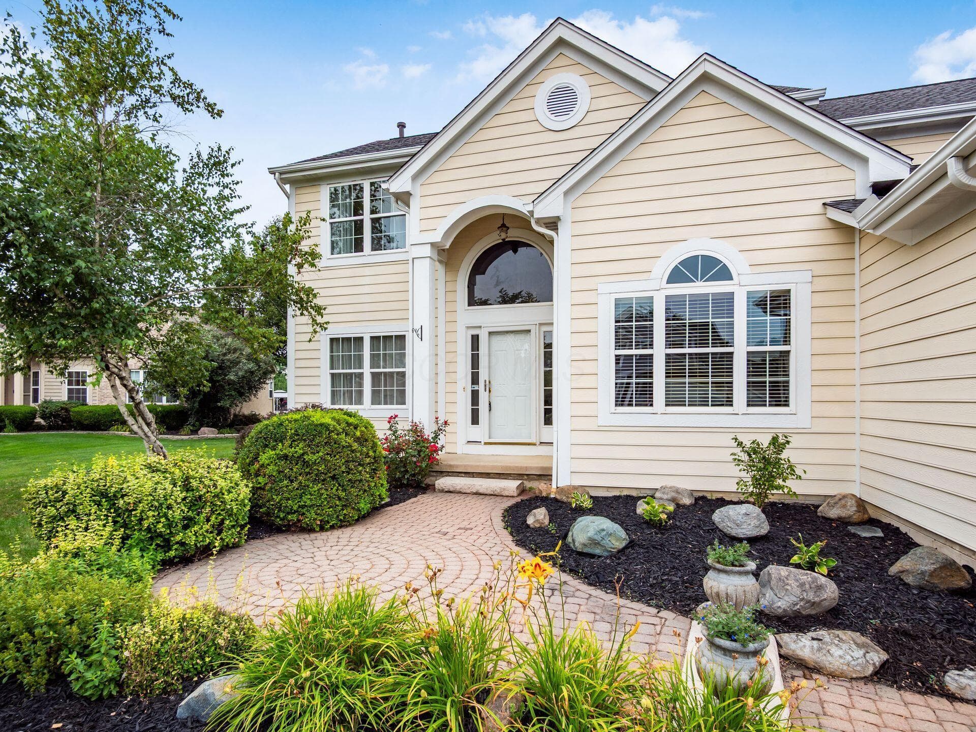 A beautiful welcoming front walk leads you into your new home!