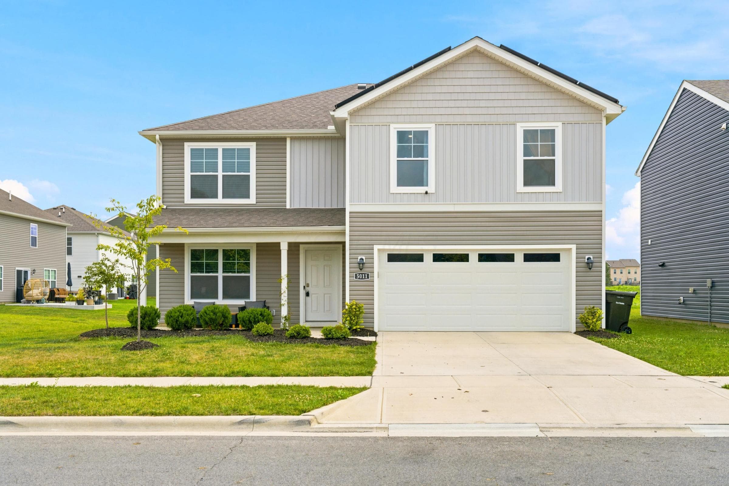 Two-story residence featuring a gray and light gray siding exterior