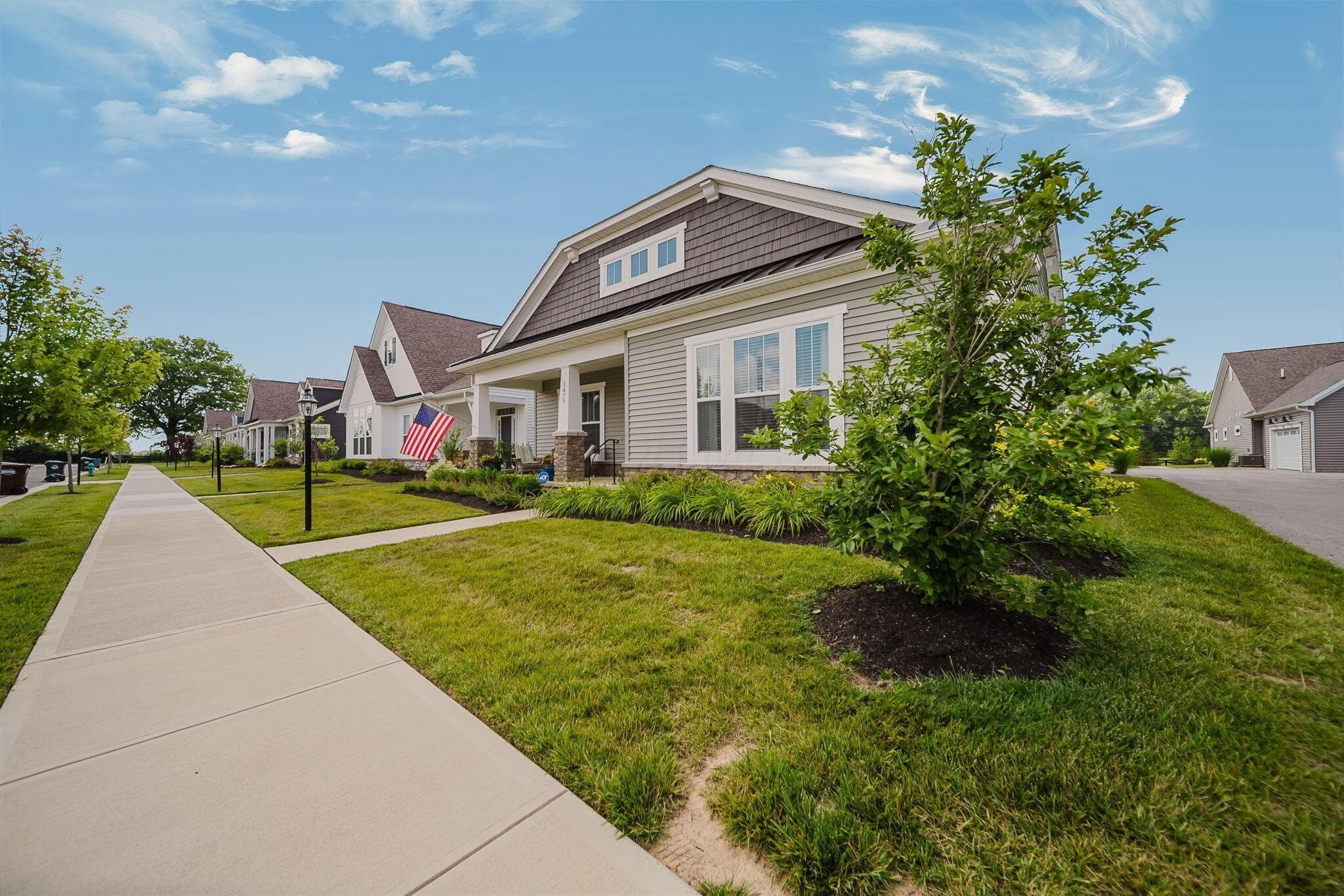 Siding exterior with stone accents and a covered front porch