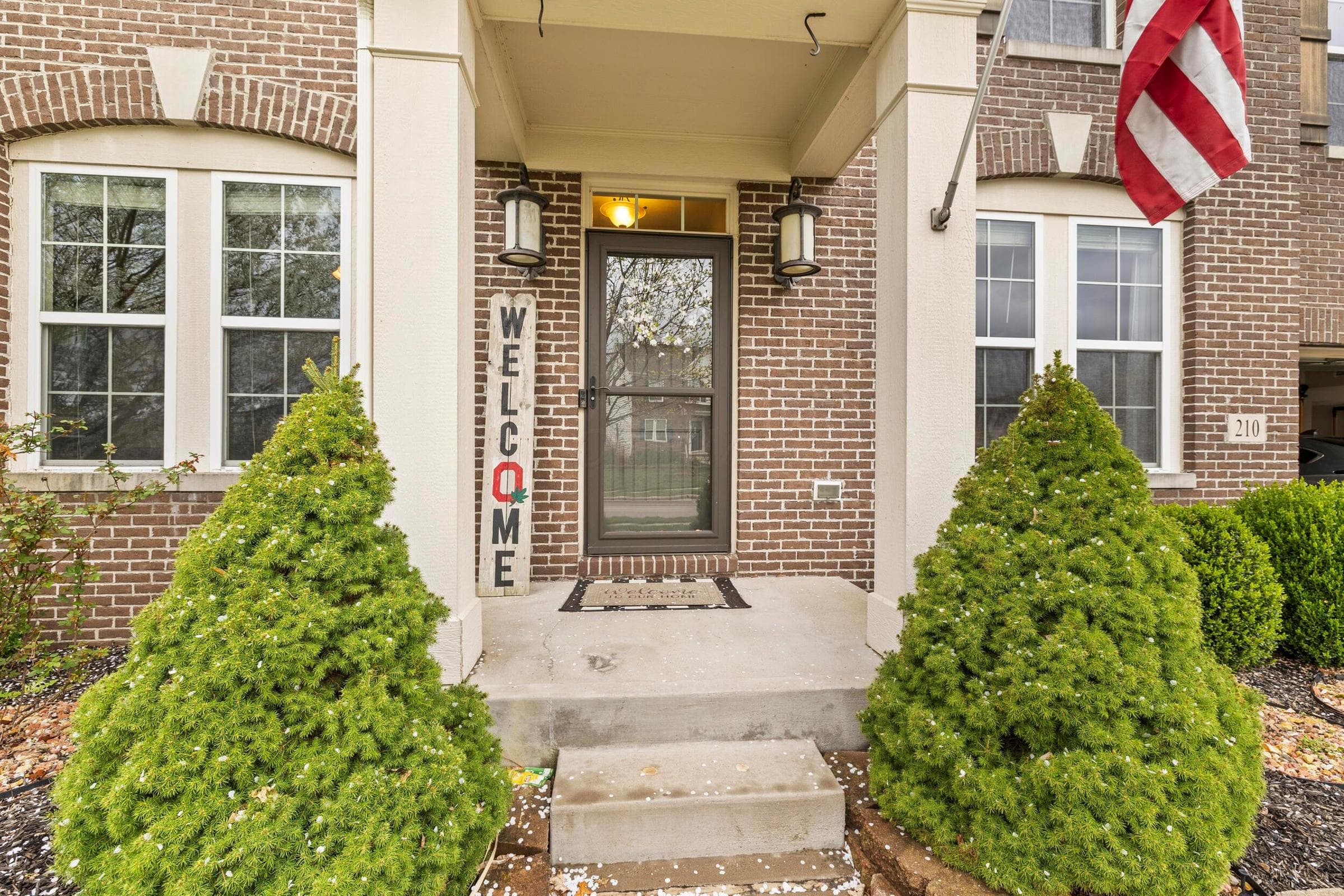 Brick exterior with white trim windows and arched detailing