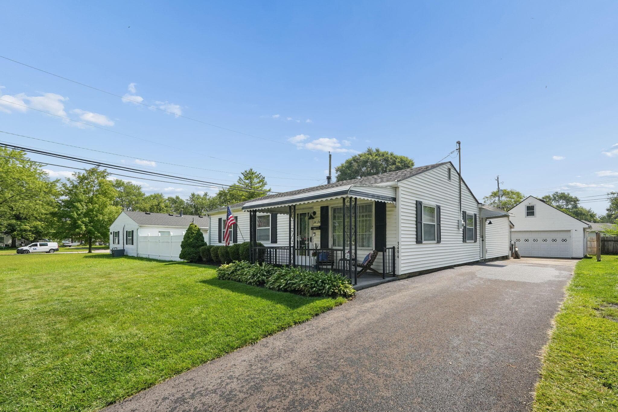 New asphalt driveway, side entrance, plenty of guest parking, and a two car garage with attic storage