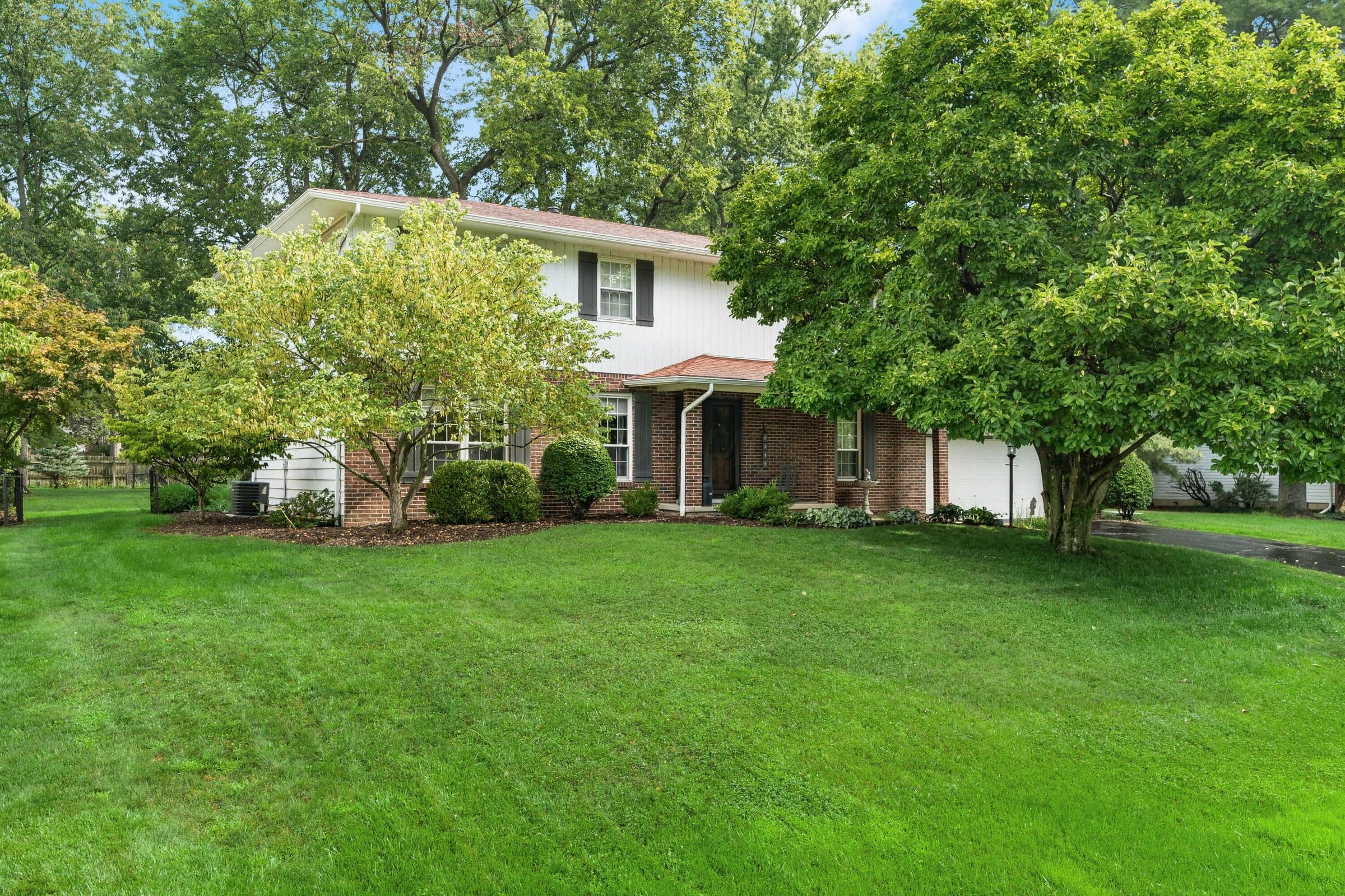Impressive curb appeal, highlighted by beautifully manicured lawn, mature trees/pristine landscaping