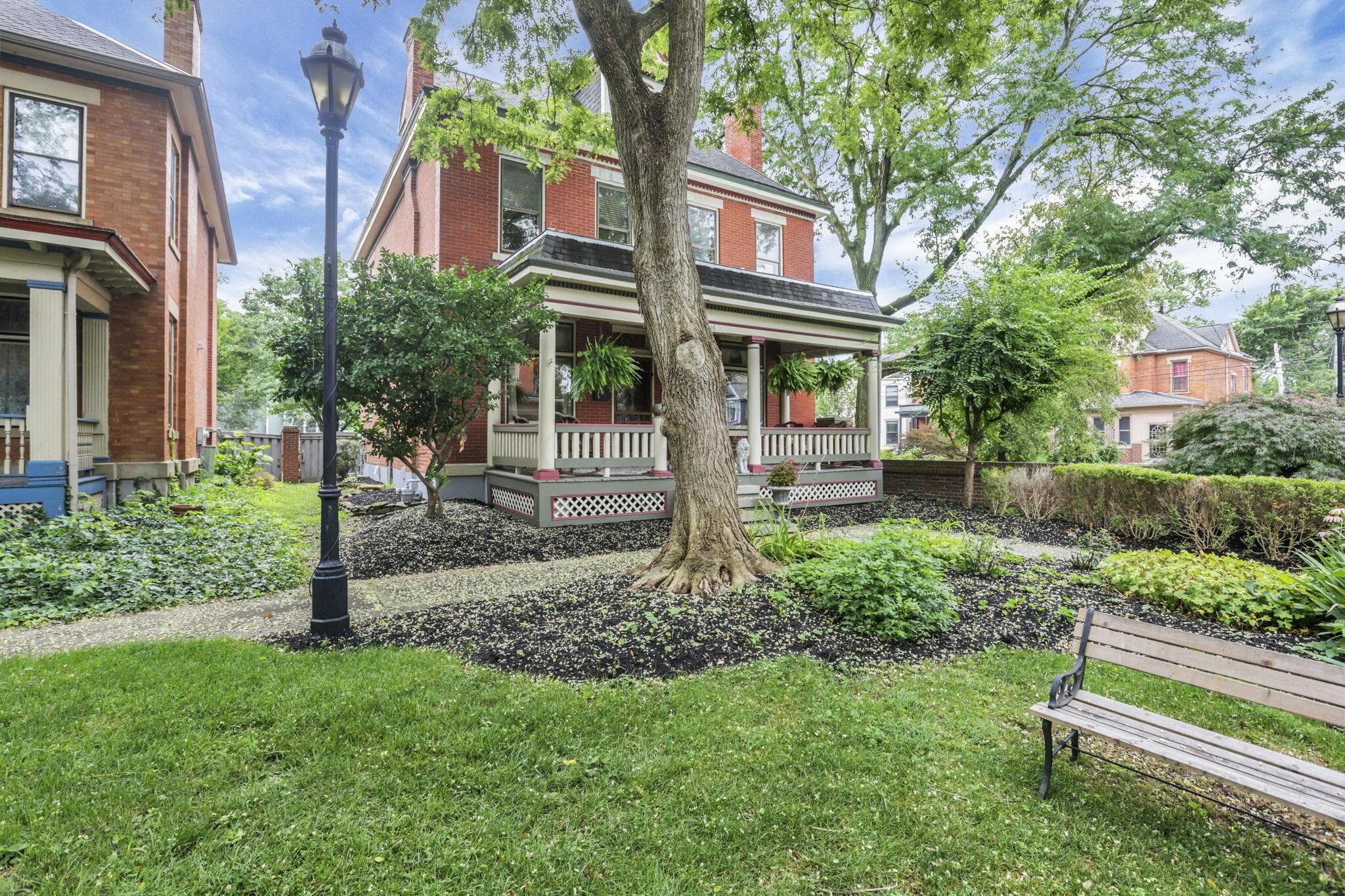 Brick exterior with a covered front porch featuring white railings