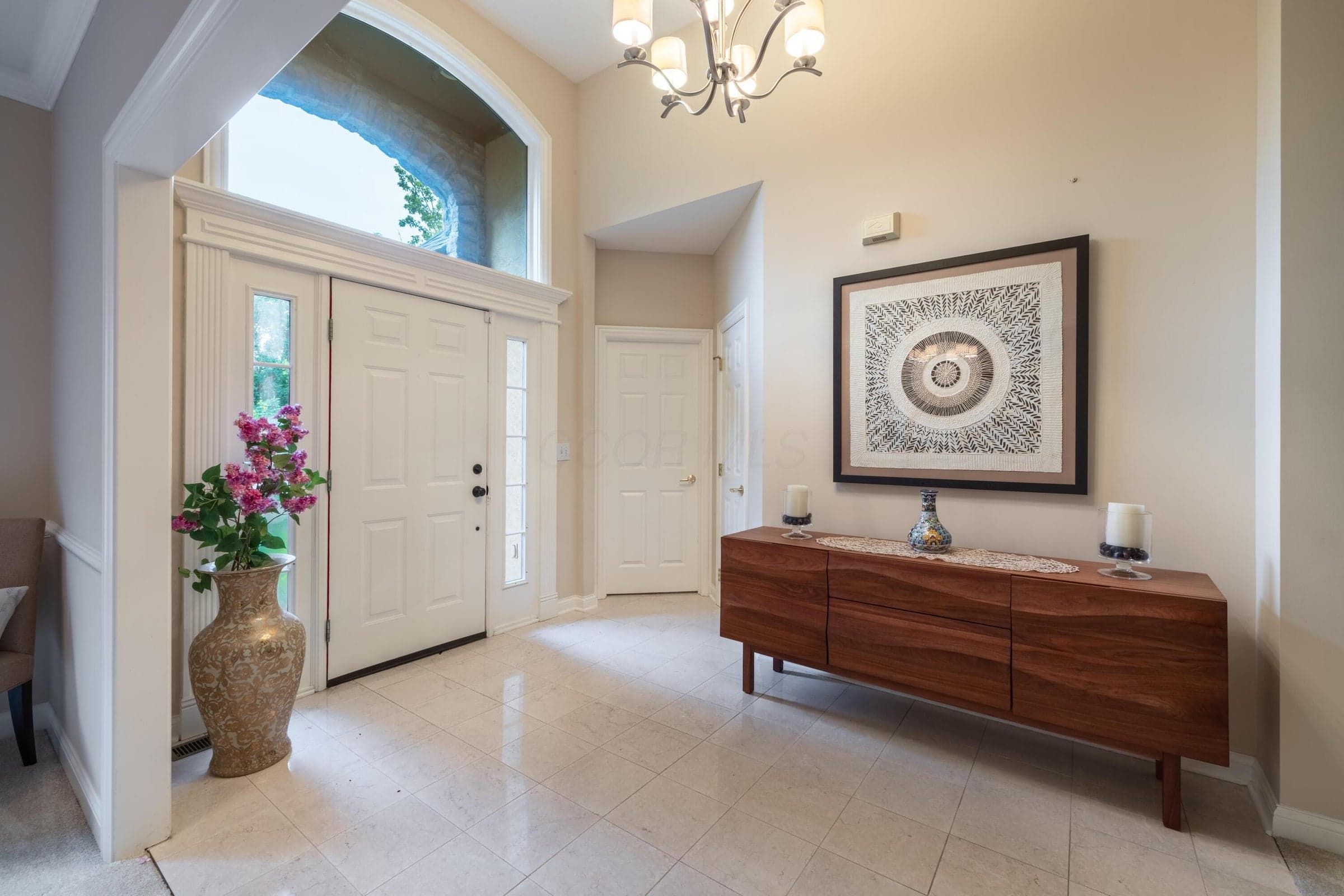 Welcoming foyer featuring a soaring ceiling, architectural window and bright, open design.