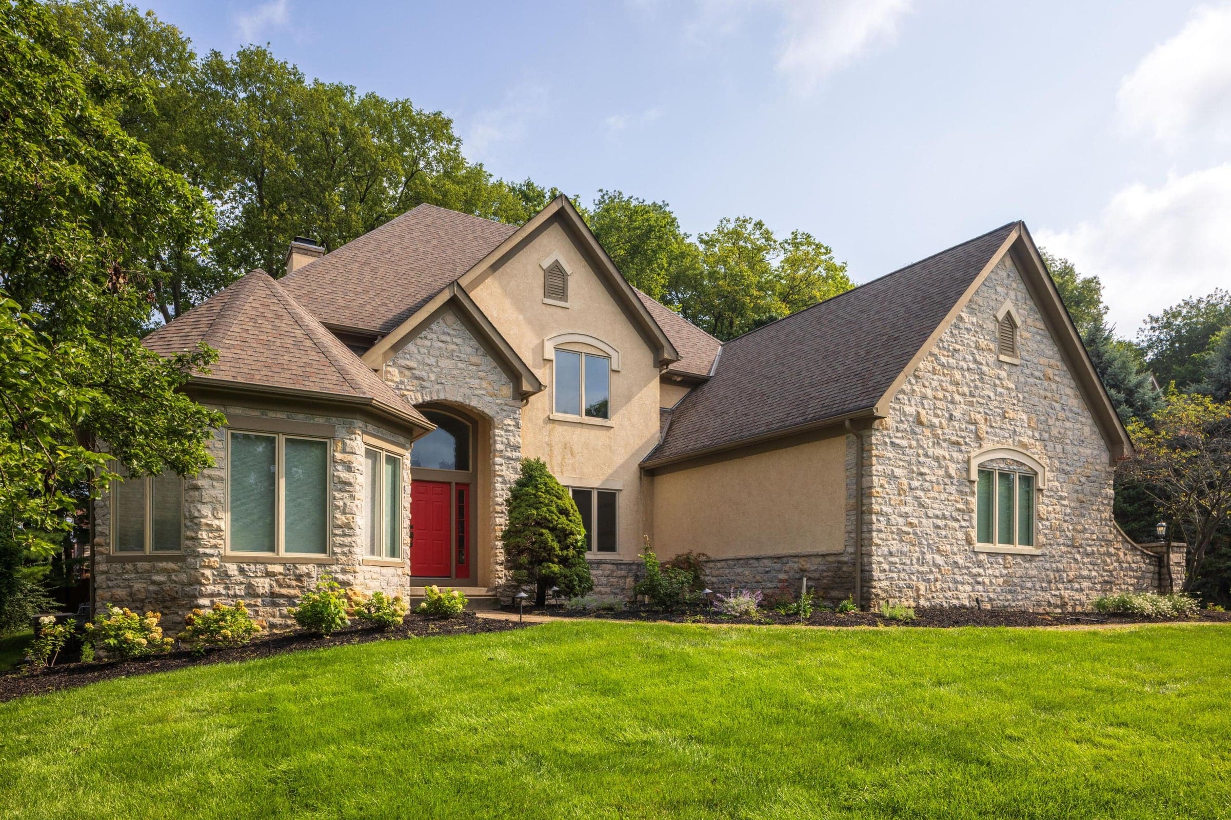 Impressive stone and stucco exterior surrounded by mature landscaping on a generous .42-acre homesite.