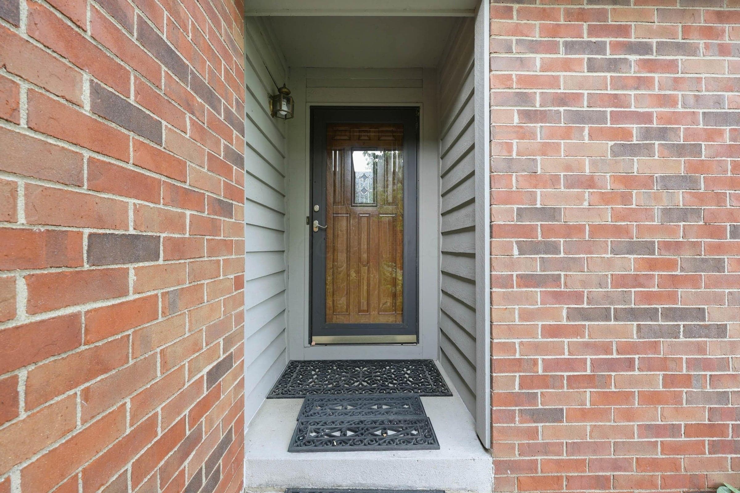 Brick exterior facade with horizontal siding accent