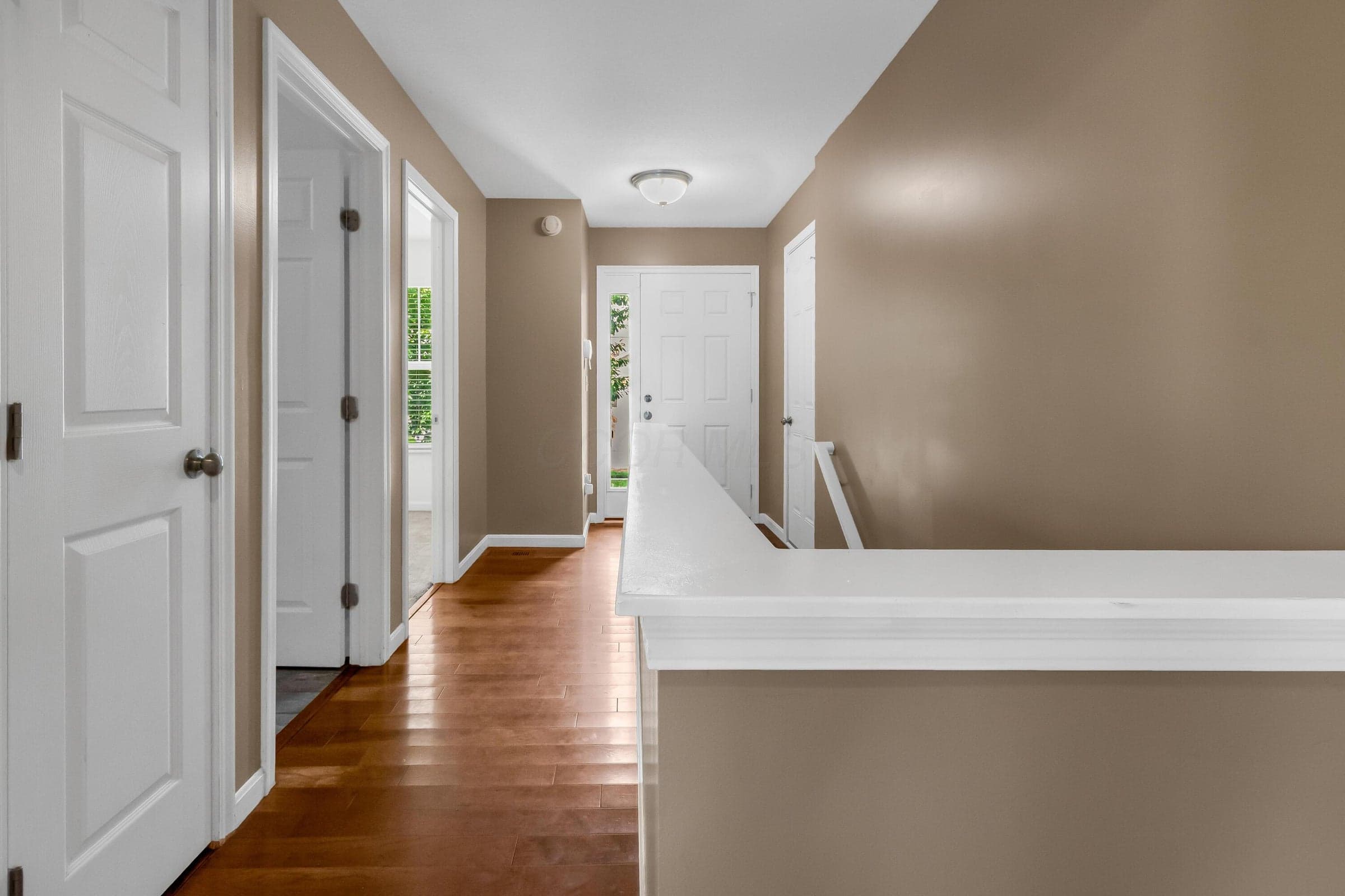 • Hickory hardwood flooring • Tan painted walls • Ceiling light • Side lights by front door • Coat closet
