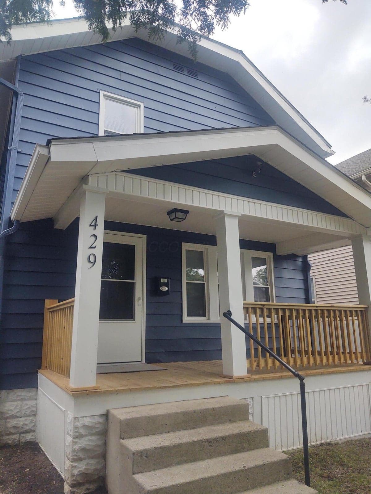 Great curb appeal, White trim, soffits with blue aluminum and vinyl siding.