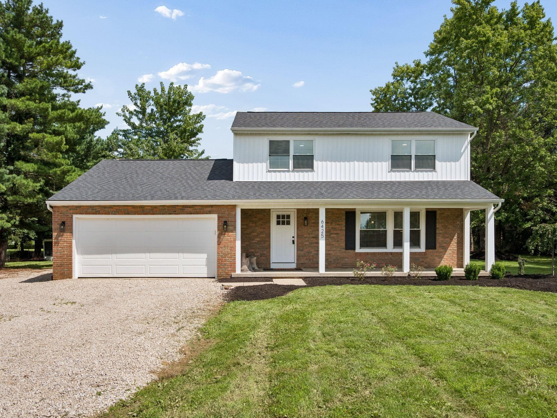 Large front porch welcomes you to this stunning property