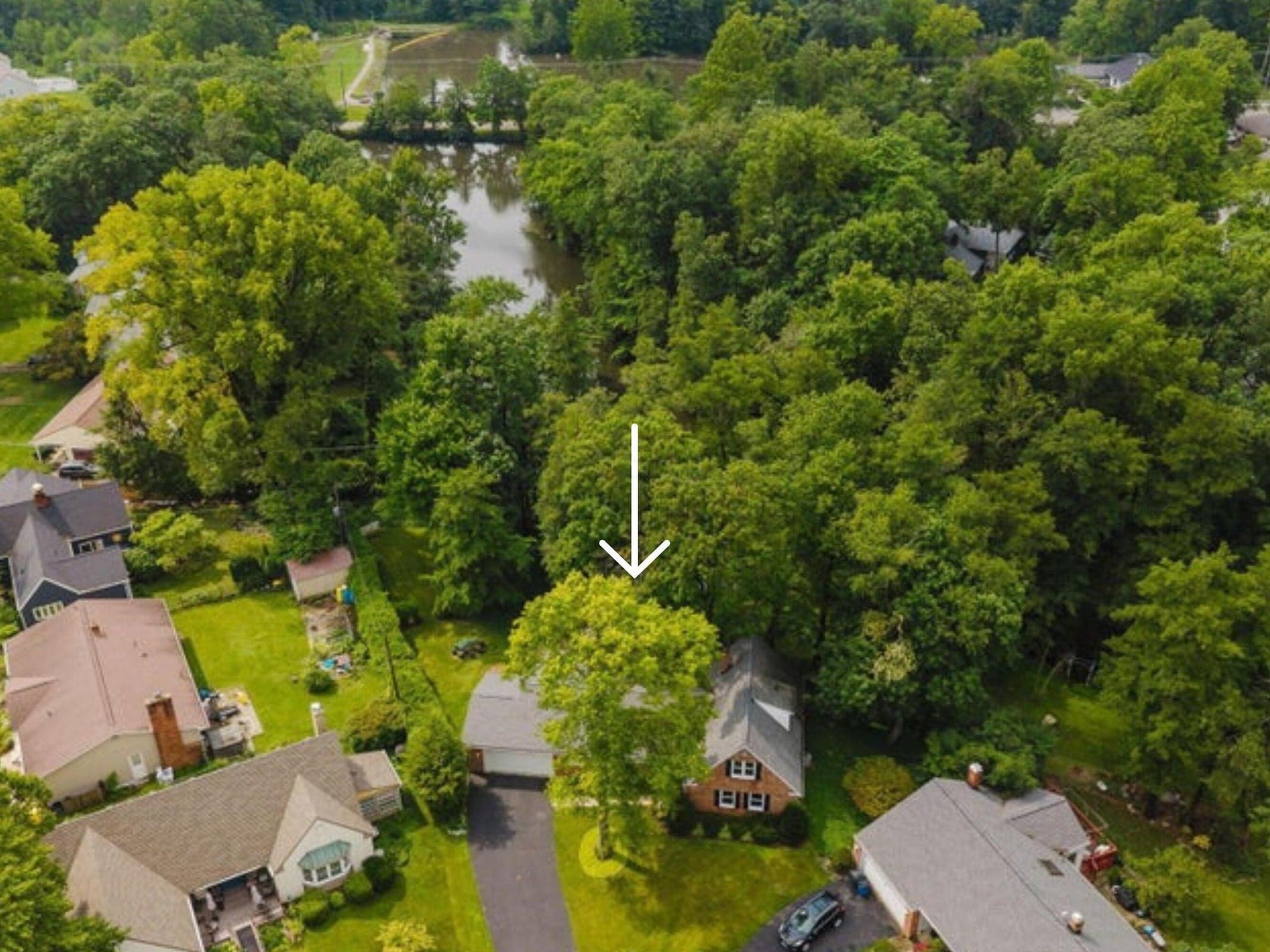 Aerial view showcasing home and Minerva Park Lake setting