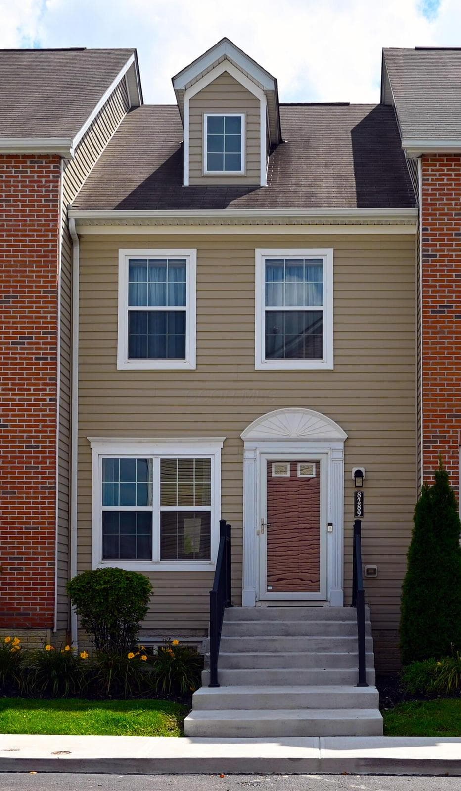 Front elevation featuring attractive architectural details, welcoming entry, and low-maintenance landscaping.