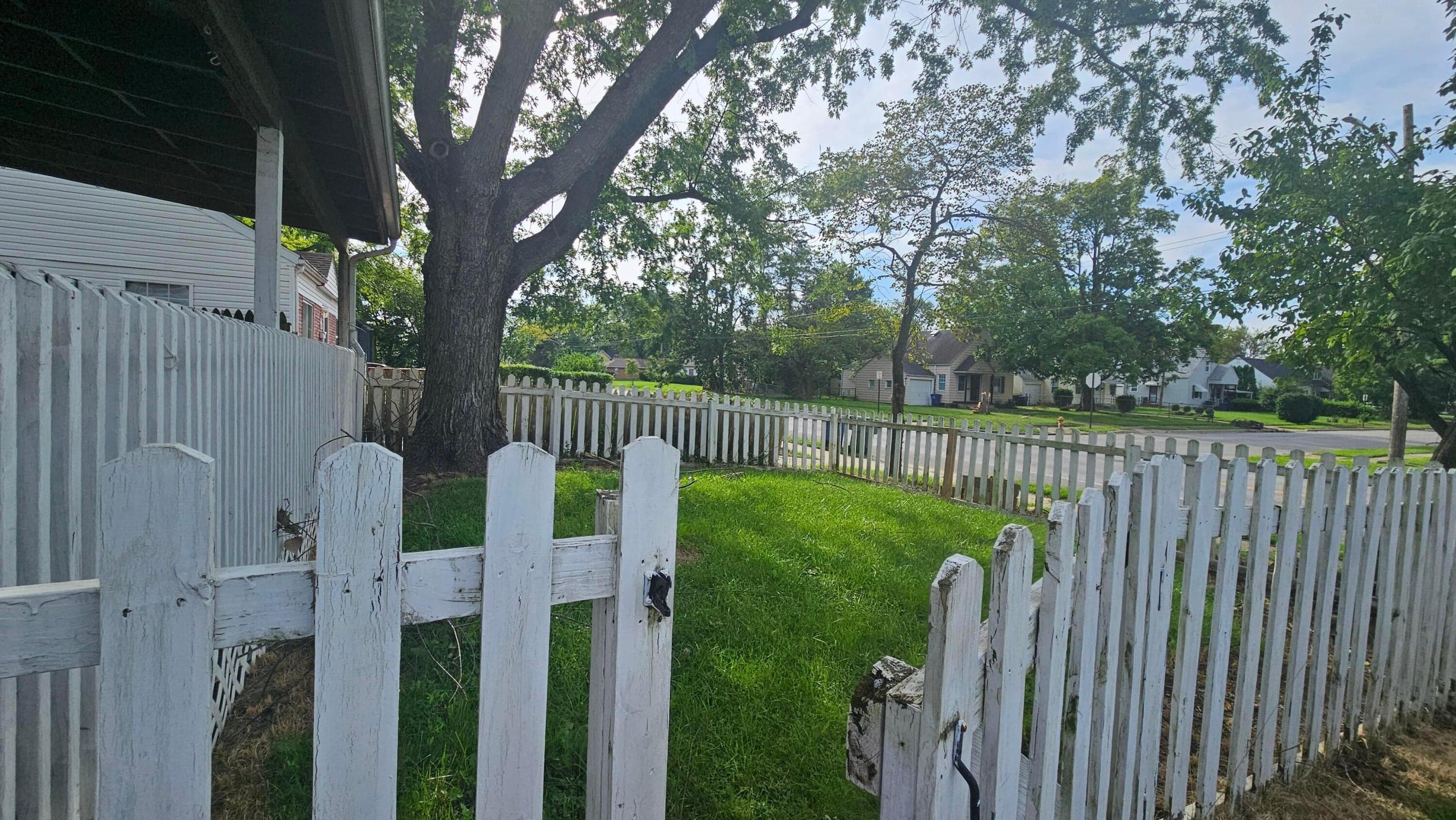 White picket fenced-in front yard.