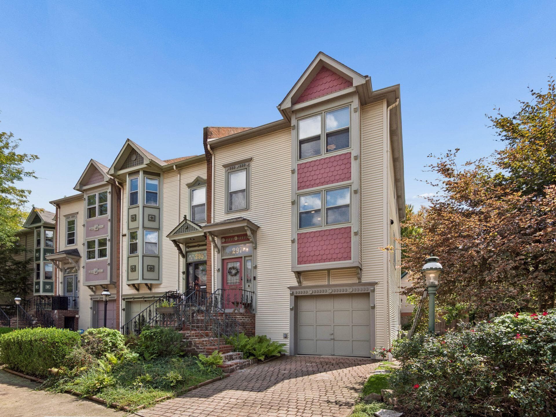 Multi-level facade with bay windows and a front-facing garage