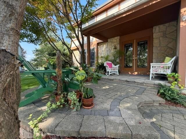 Elevated front Paver Patio with covered front porch.
