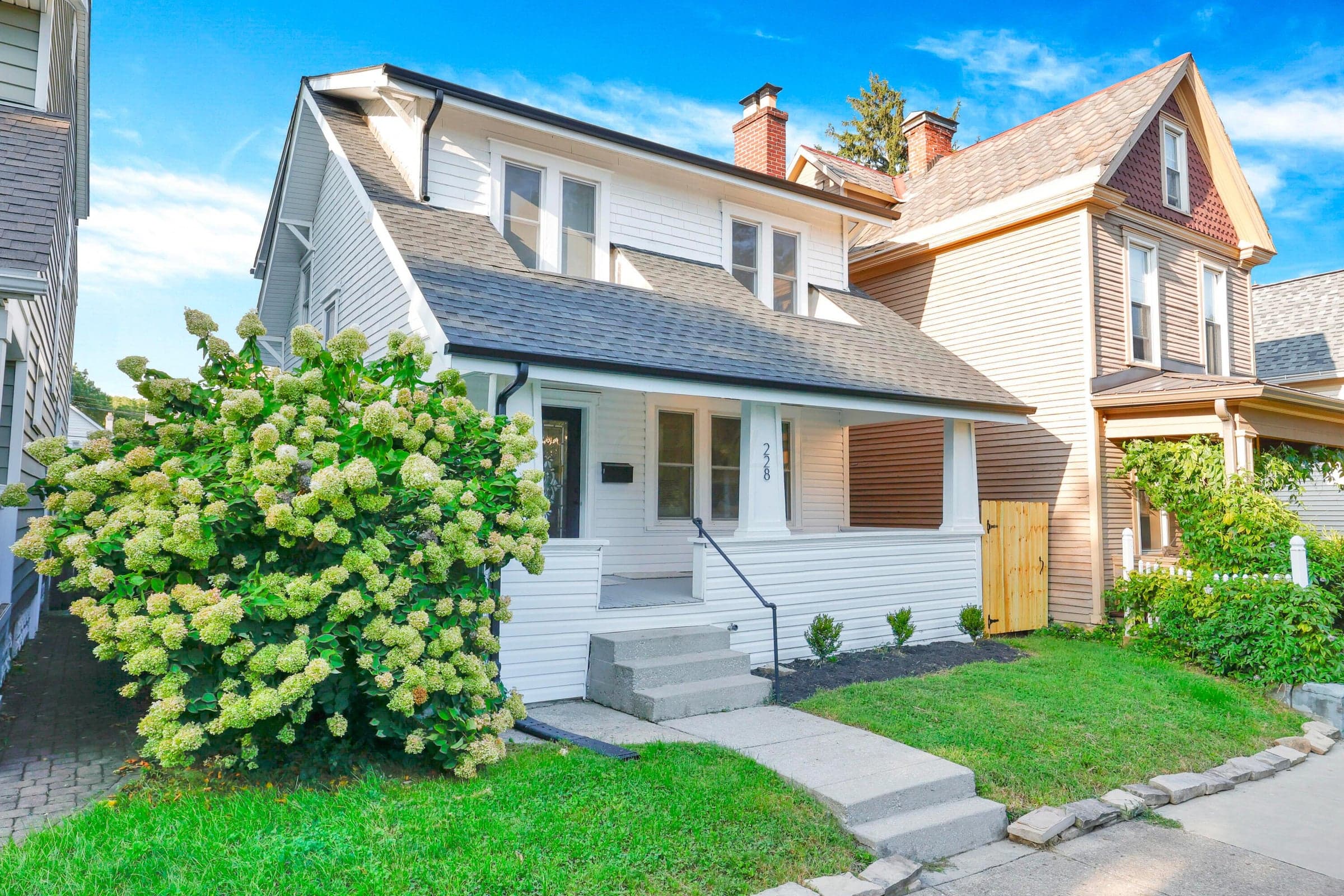 White siding exterior with a dark shingle roof