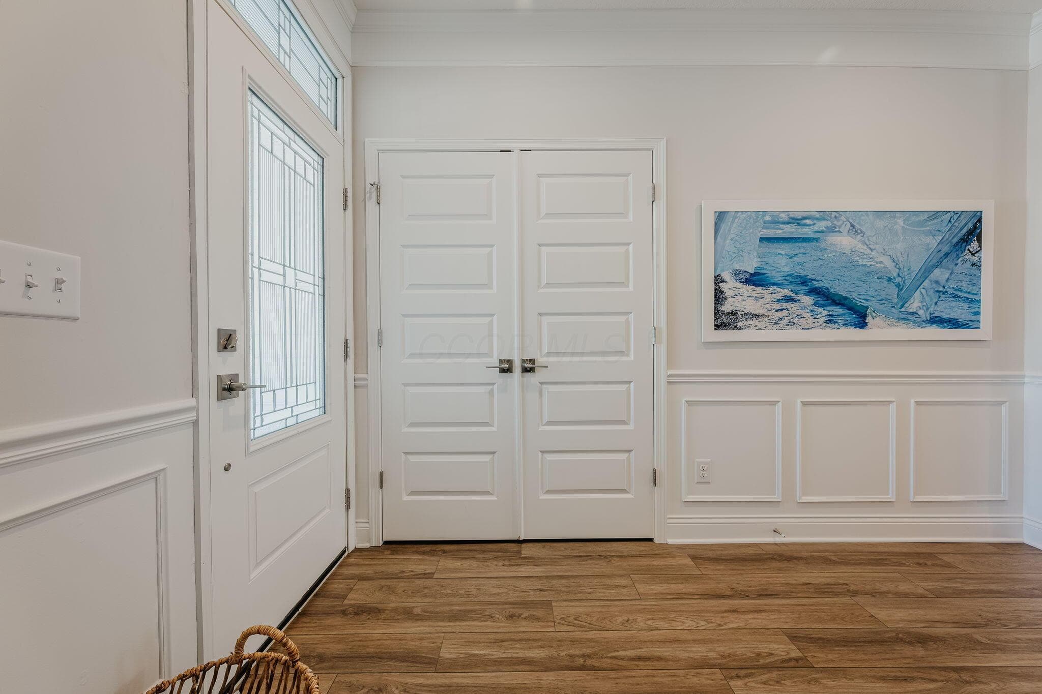 Welcoming entry with ugraded glass door and detailed millwork