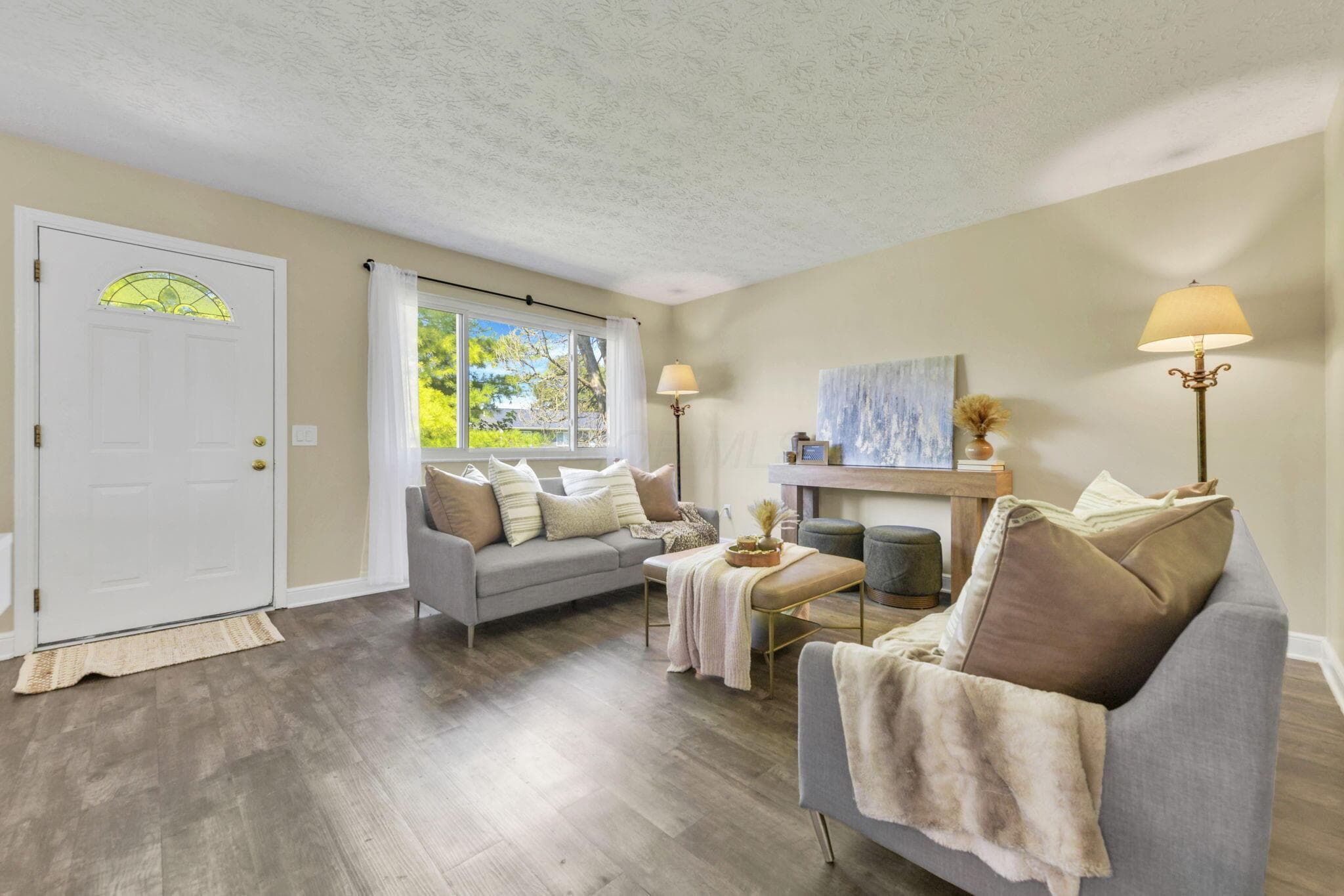 Living Room with New LVP Flooring, Fresh Paint, and Natural Light