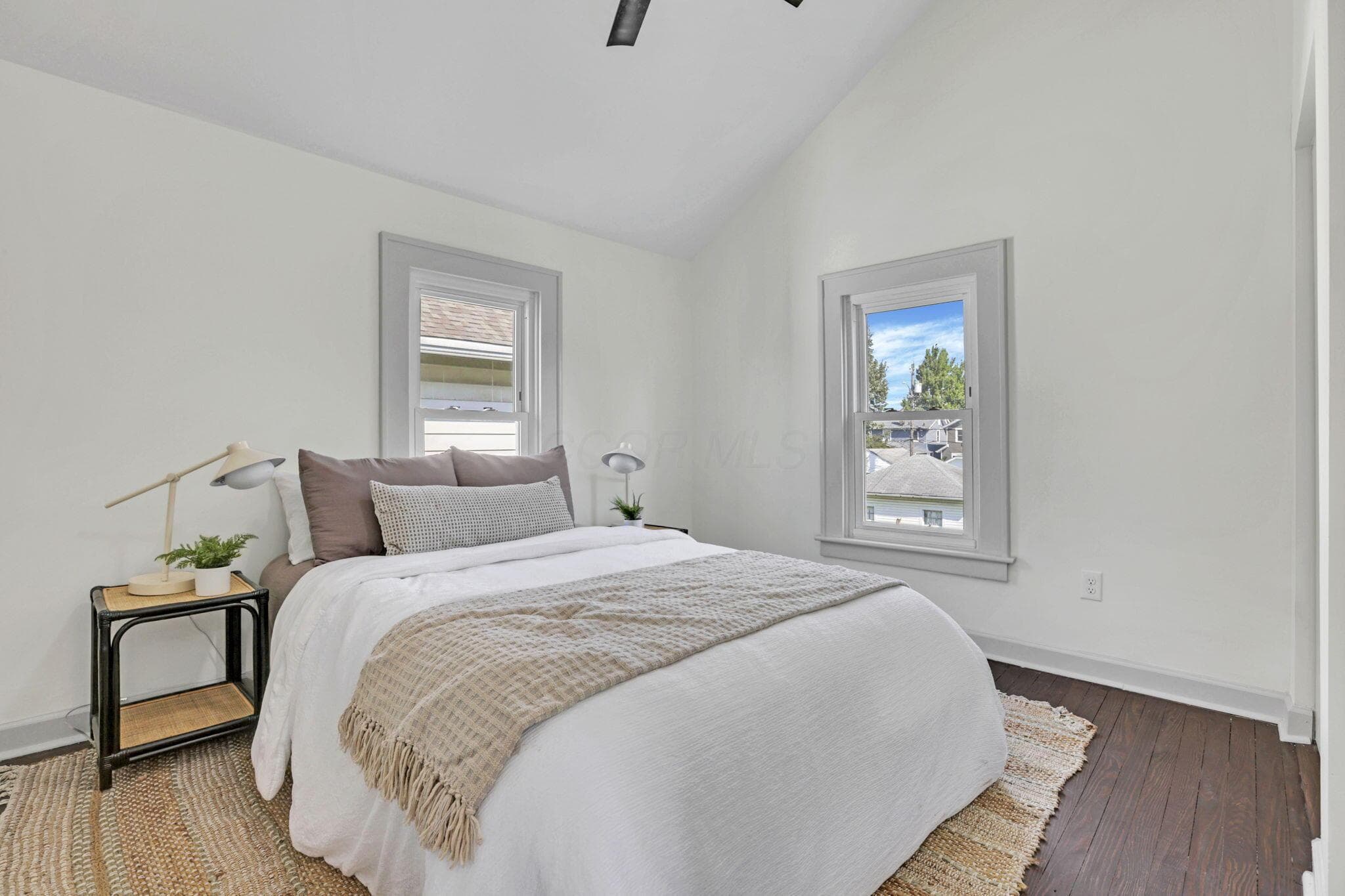 Vaulted ceiling with a ceiling fan, recessed window trim, and dark wood-finish flooring