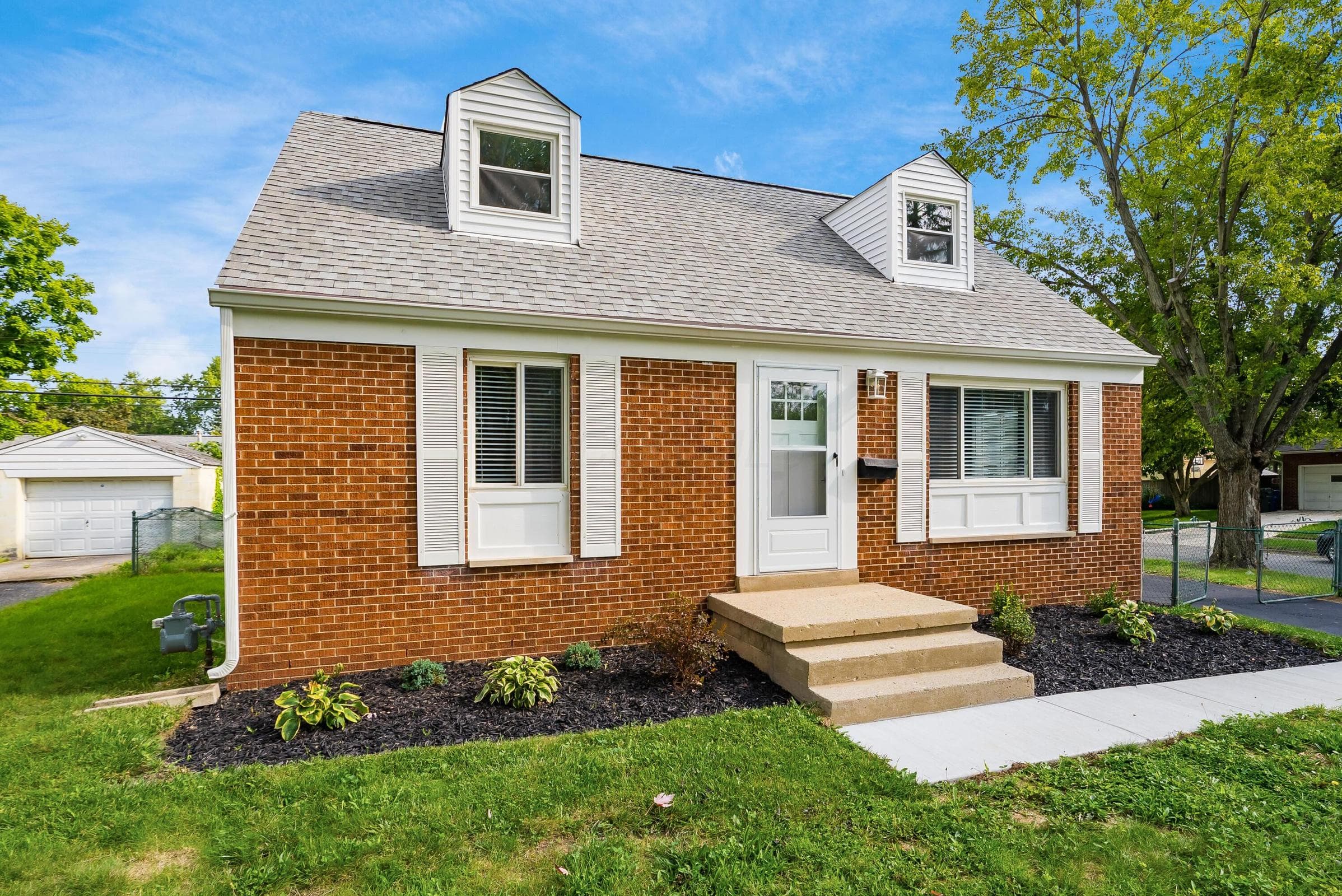 Brick exterior with white window shutters