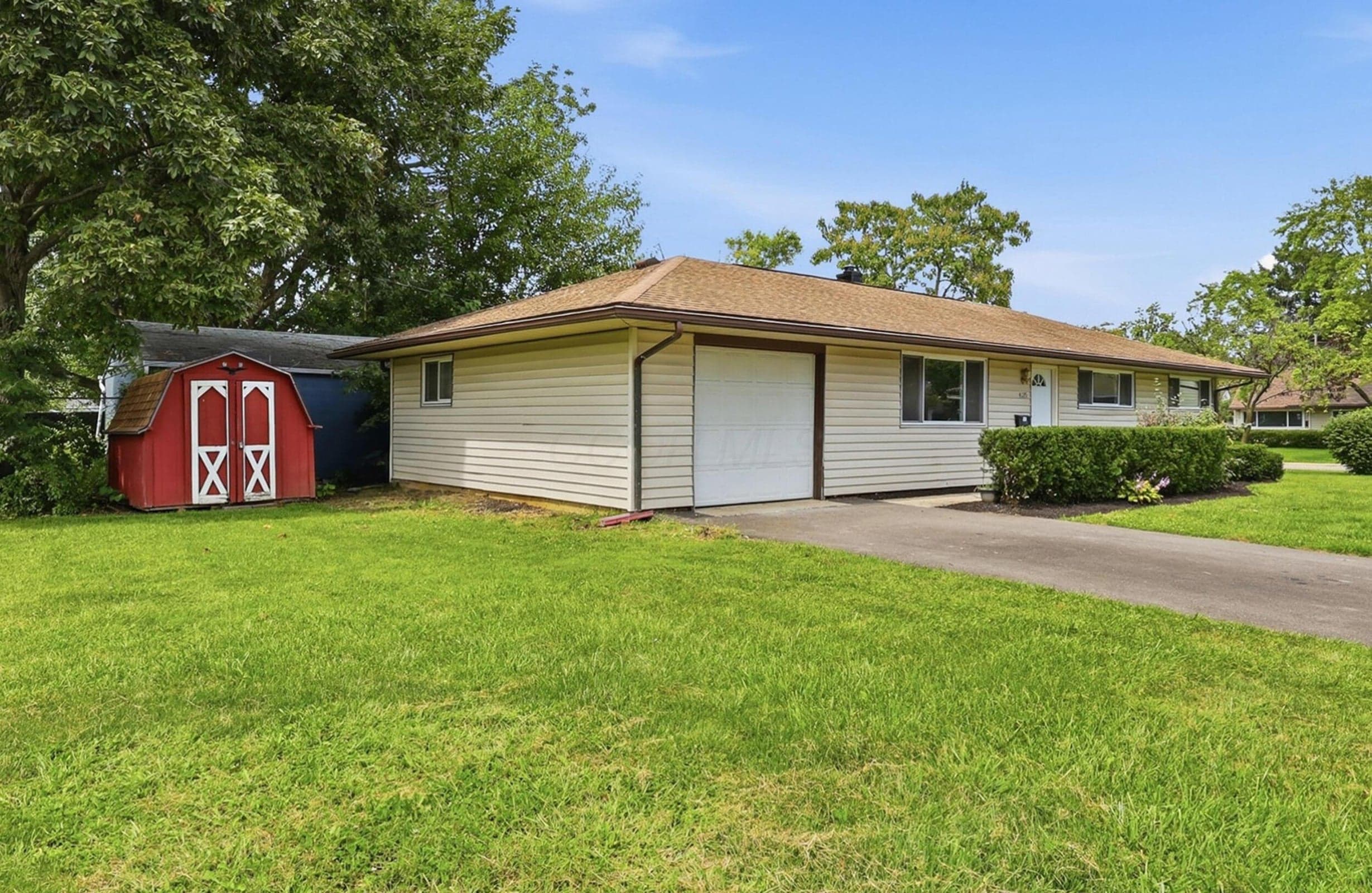 Spacious side yard with a shed that offers ample storage space.
