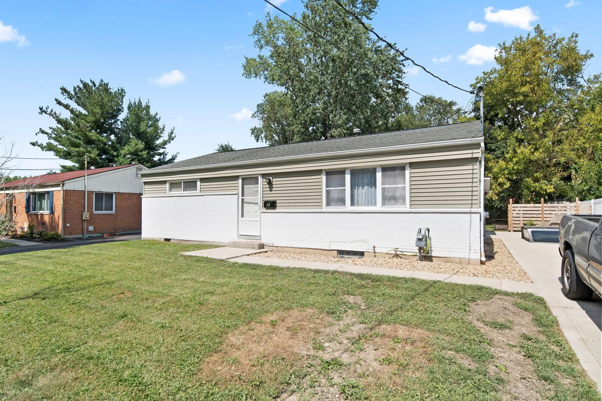 Single-story exterior with horizontal siding and a paved driveway.