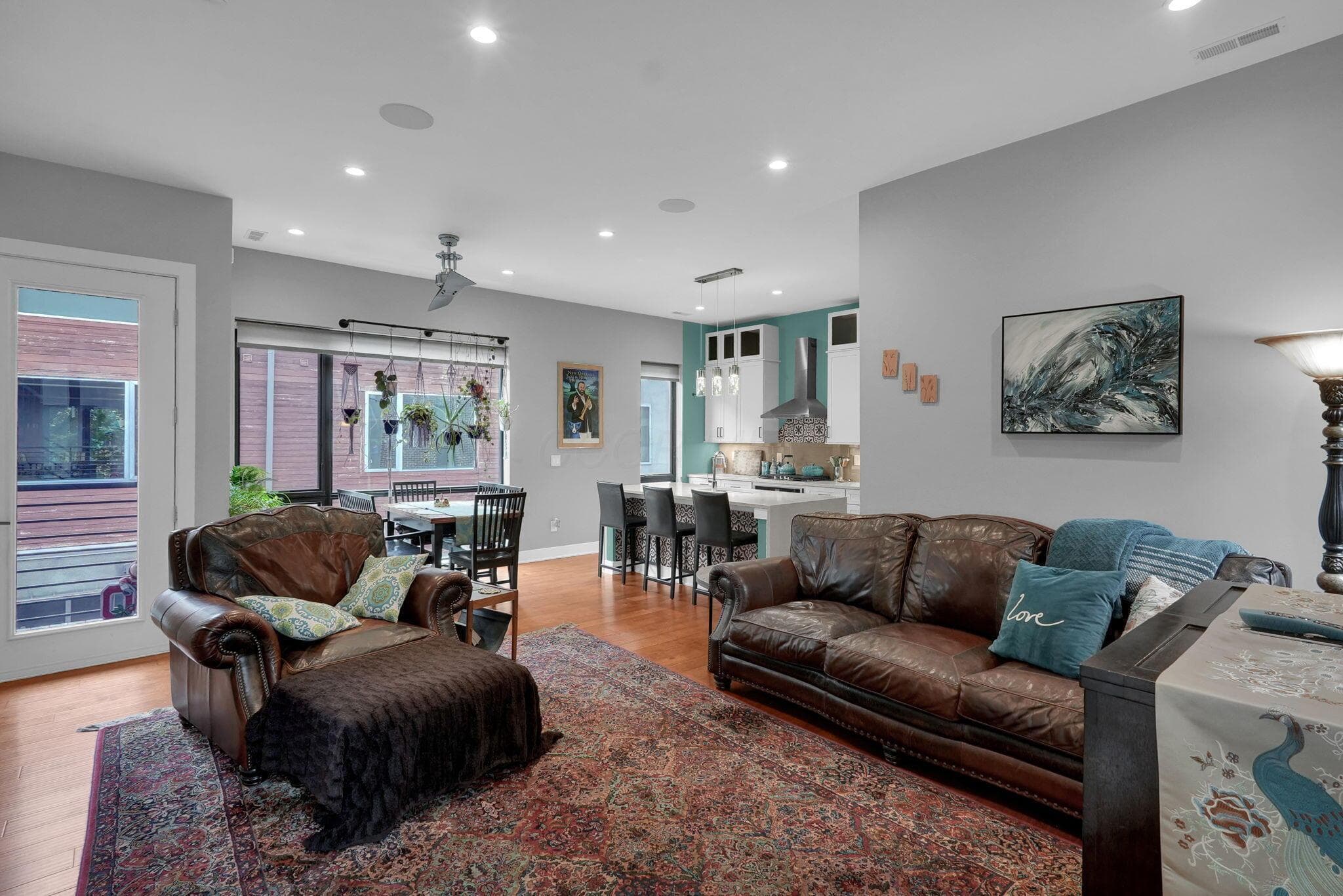 Open-concept living space featuring wood-finish flooring and recessed lighting