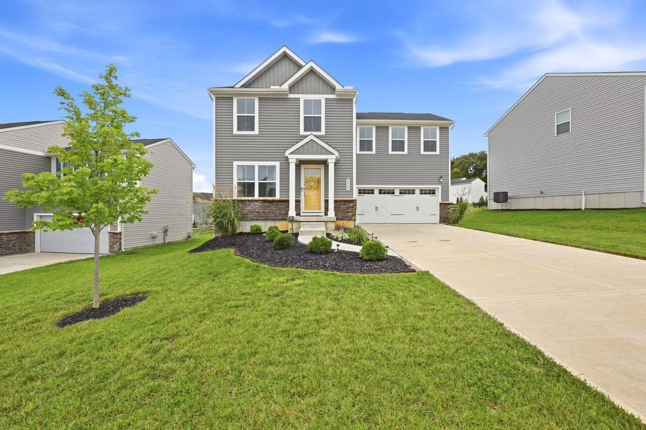 Covered porch and cement driveway.