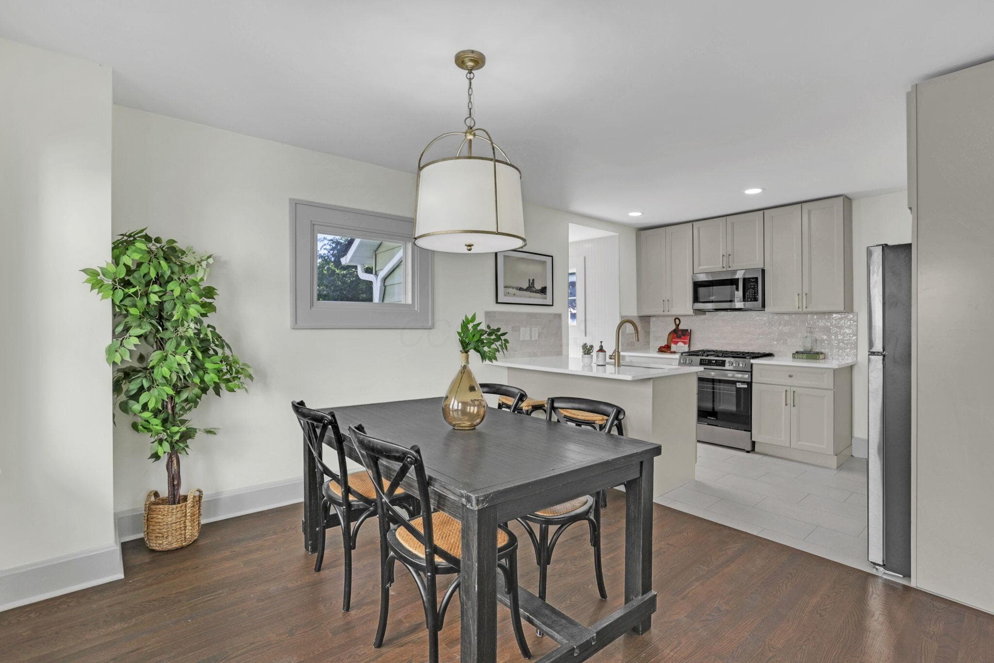 Large open dining area between the kitchen and the living room. Original french doors separate the dining room from the living room.