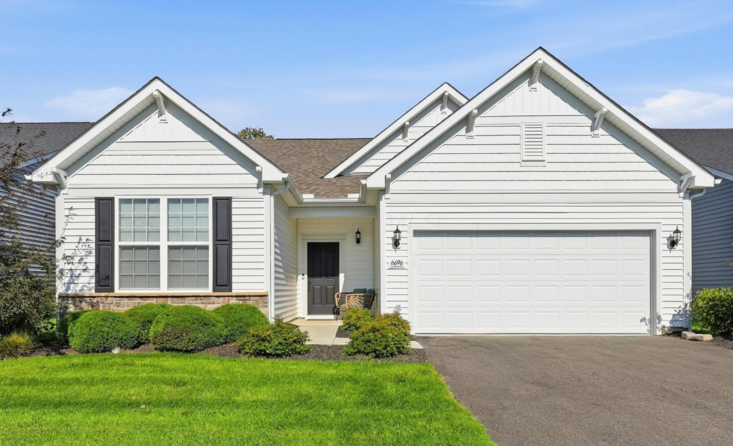 White siding exterior with a stone accent