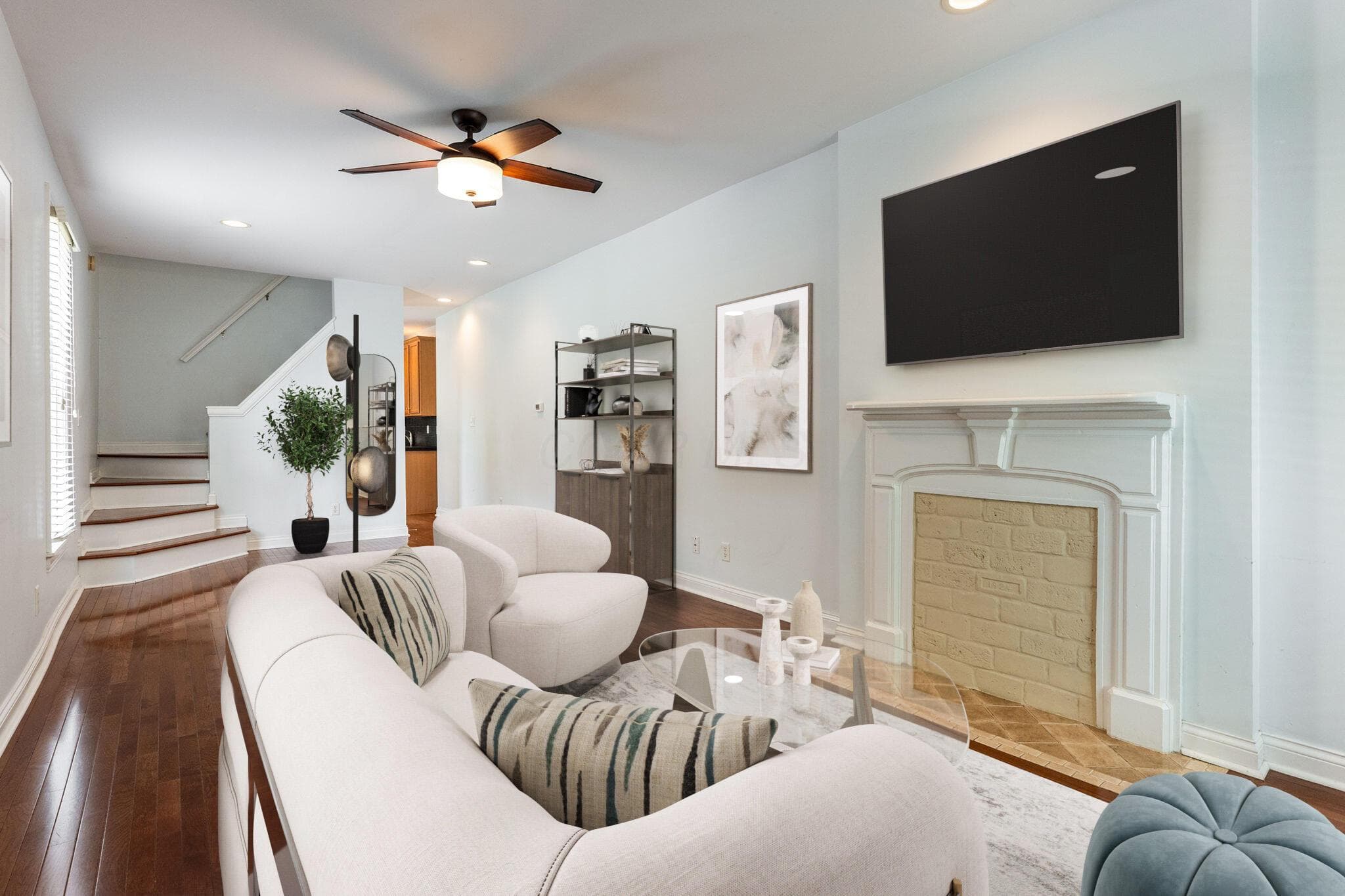 The updated condo has an open floor plan and the great room features wood floors, a decorative fireplace, 9' ceilings , with ceiling fan and recessed lighting.
