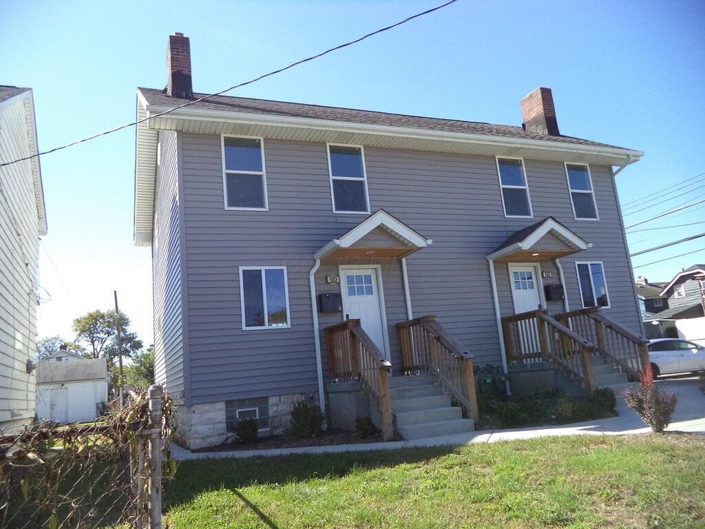 Two-story duplex with gray siding and white trim