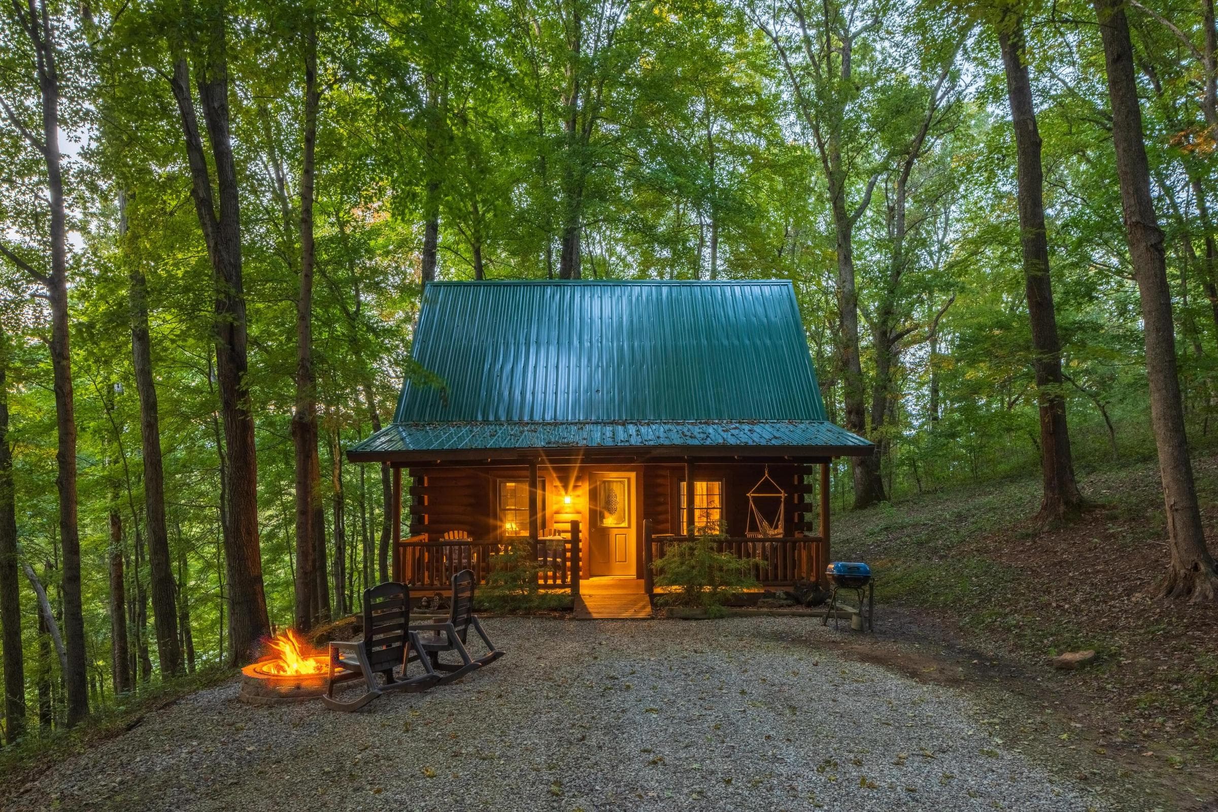 Beechwood Cabin Classic log-cabin exterior with covered porch and wooded surroundings.