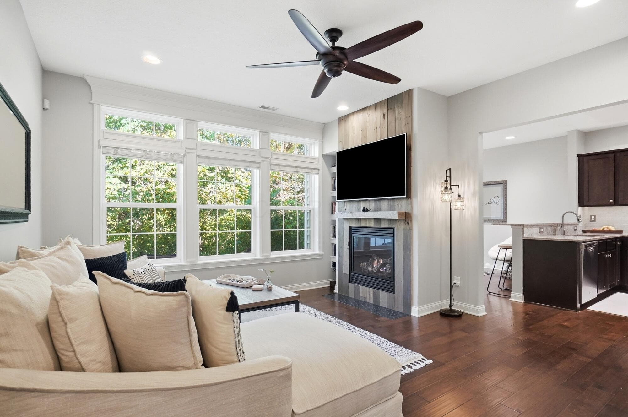 Gorgeous living room with upgraded fireplace using 100 year old repurposed wood and new tile work.