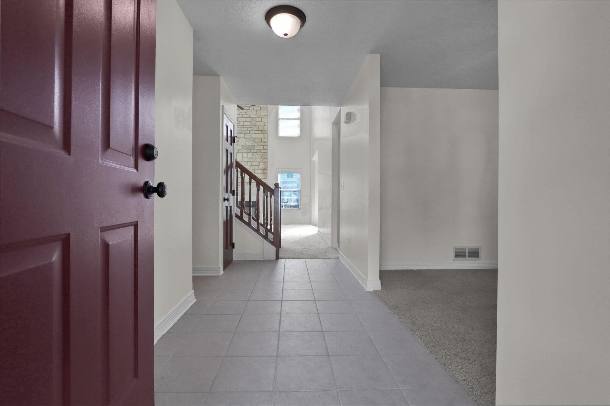 Ceramic tile foyer and neutral color palette greets you upon entry.